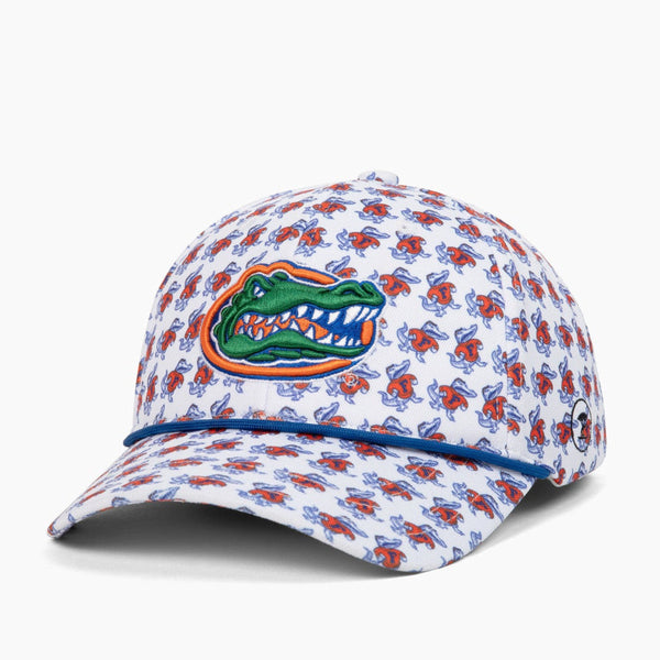 A white baseball cap featuring a repeating red and blue floral pattern, with a green and orange Florida Gators alligator logo embroidered on the front. The cap is photographed on a clean, light gray background.