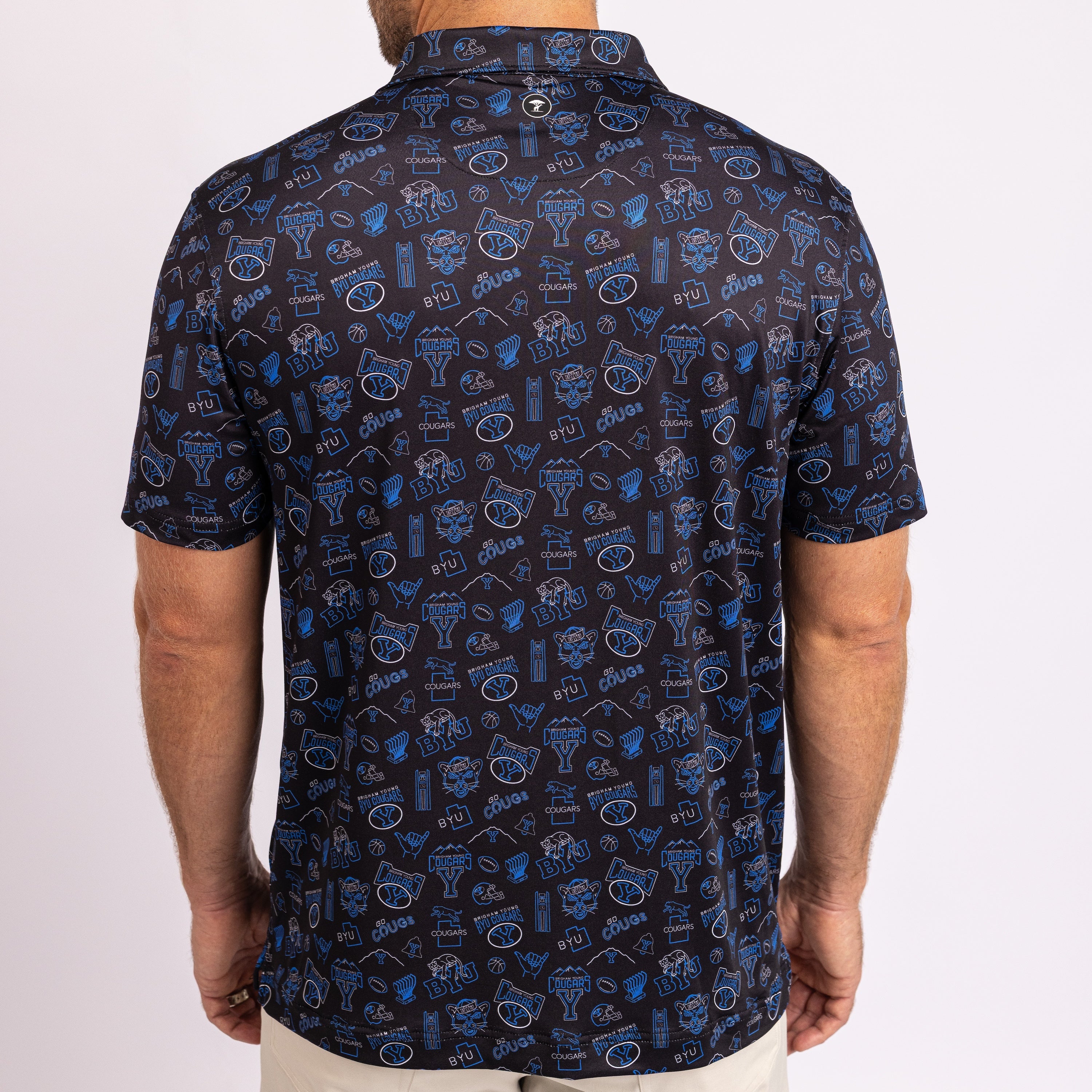 A man wearing a short-sleeve button-up shirt from the back, featuring a dark navy blue base covered