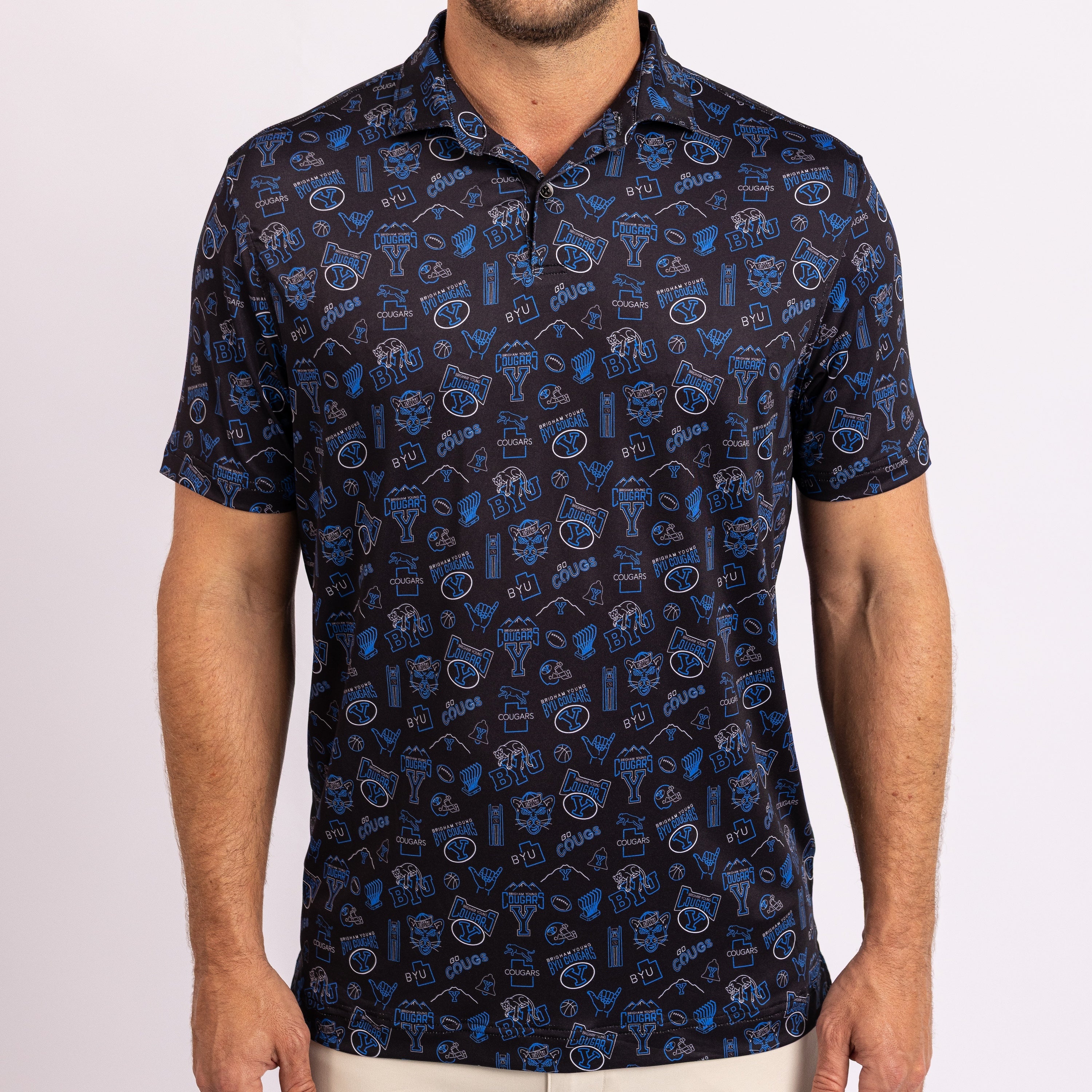 A man wearing a short-sleeve polo shirt with a dark navy blue base and an all-over pattern of blue and white.