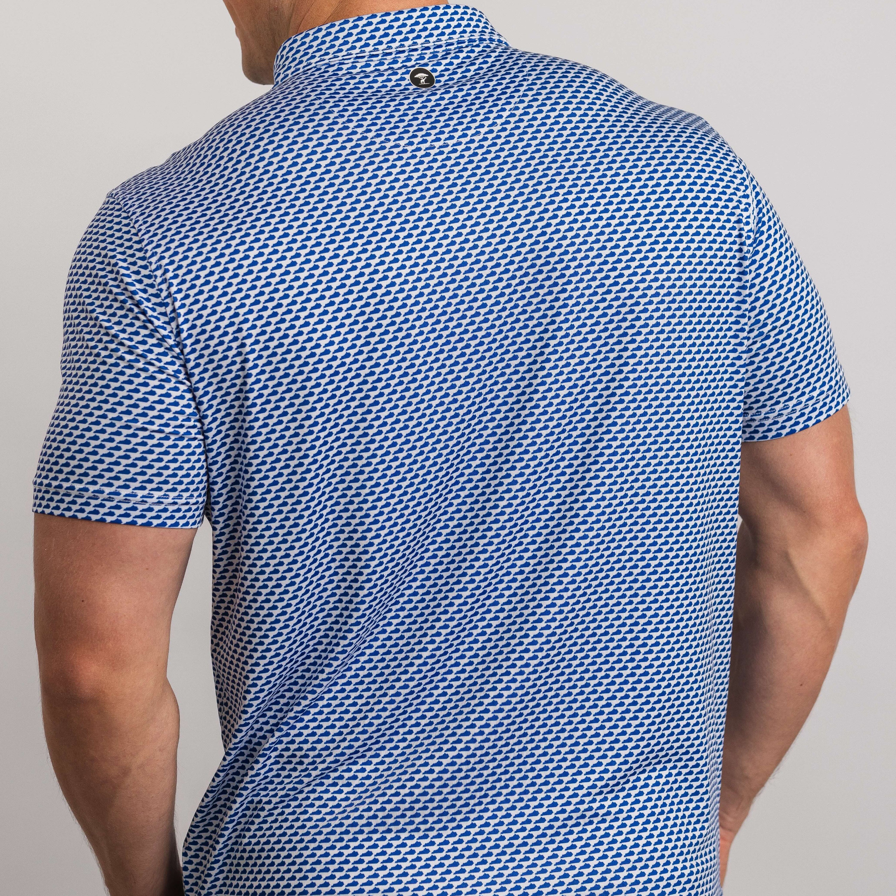 Man wearing a blue patterned shirt on a plain background