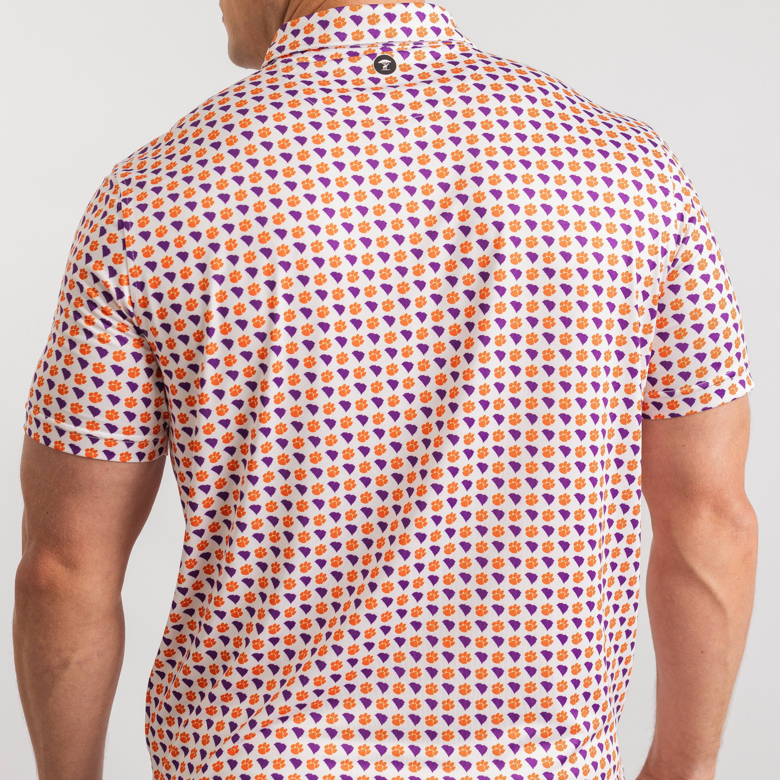 Person wearing a patterned shirt with geometric design on a plain background