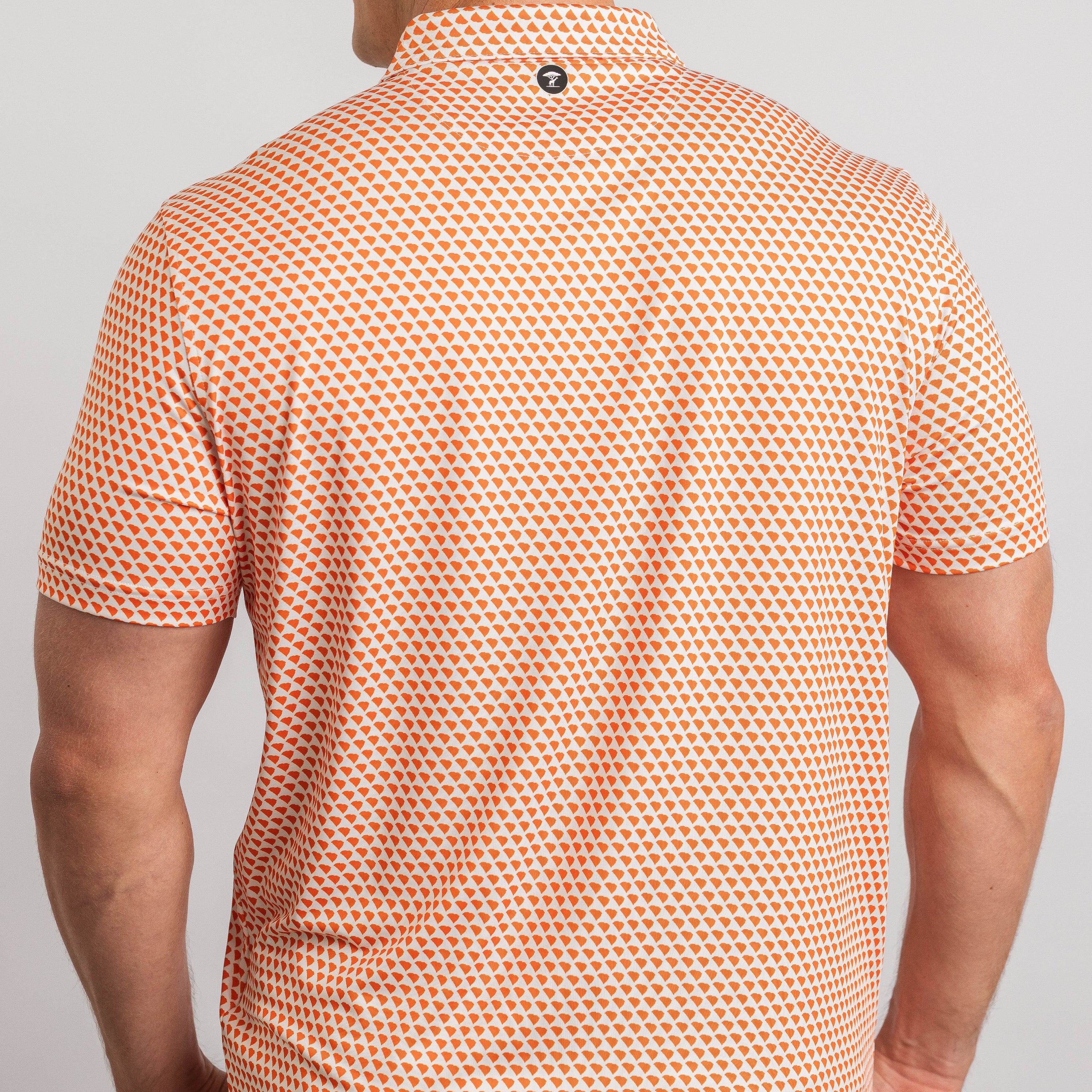Person wearing an orange and white patterned shirt on a plain background