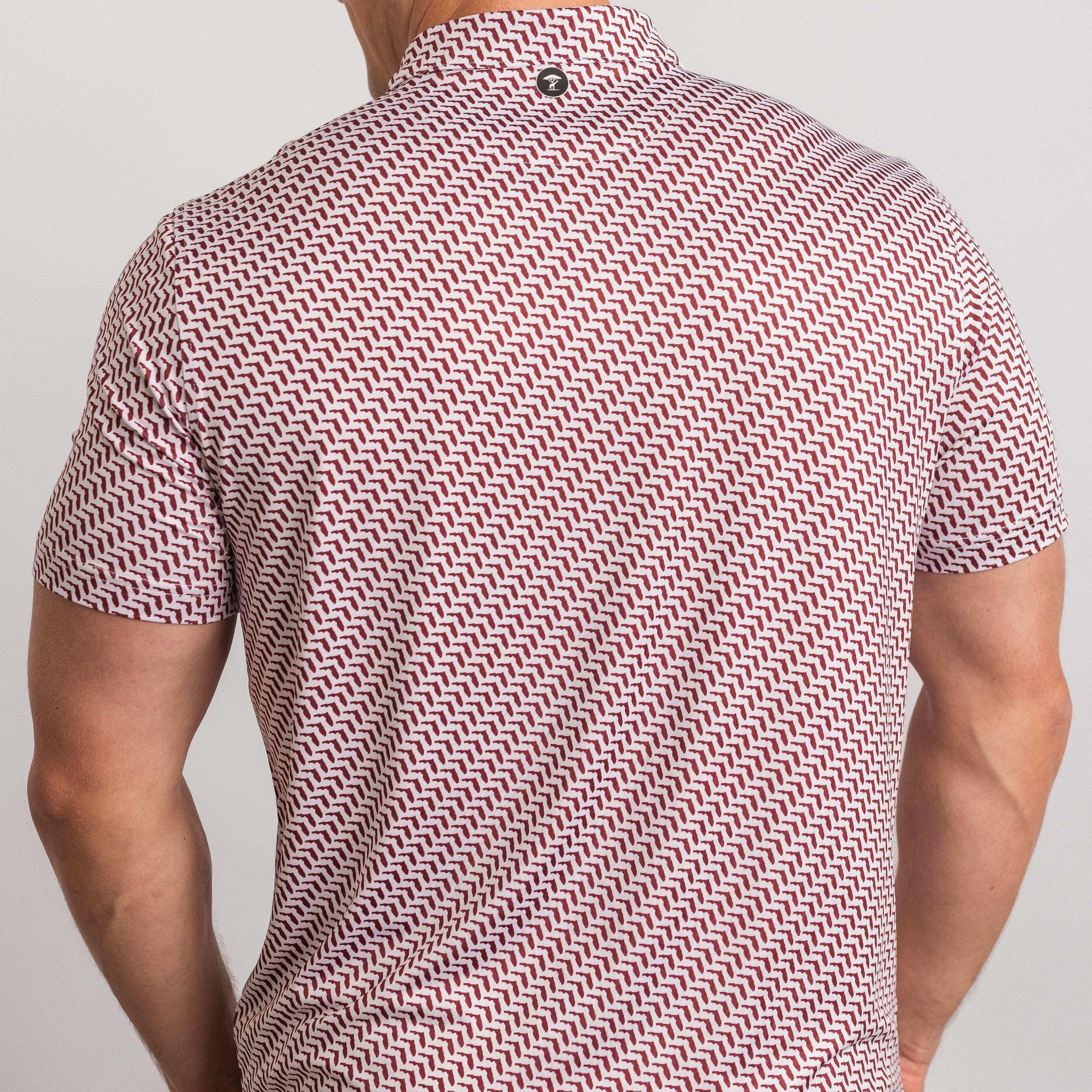 Man wearing a patterned shirt with a plain background