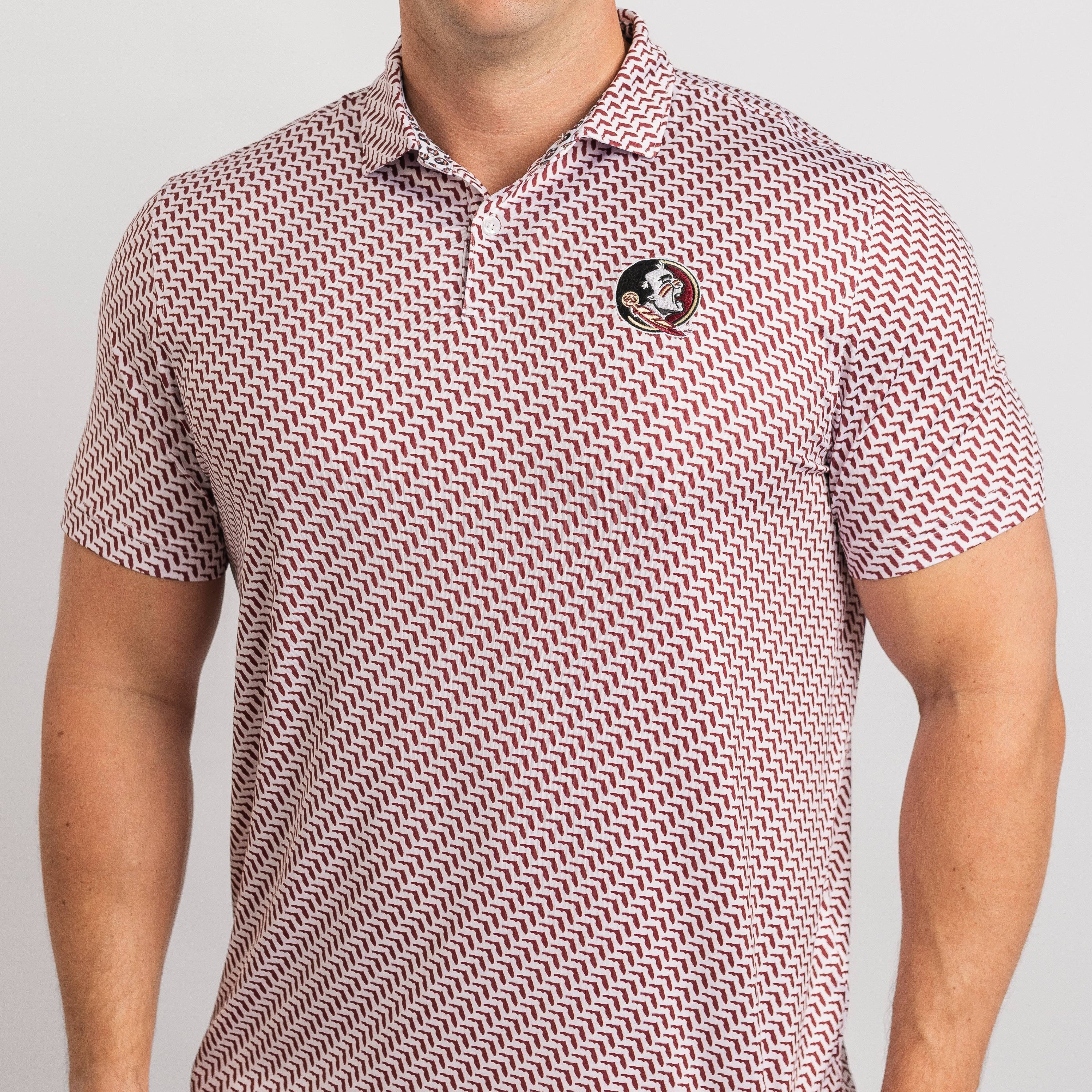 Person wearing a patterned polo shirt on a plain background