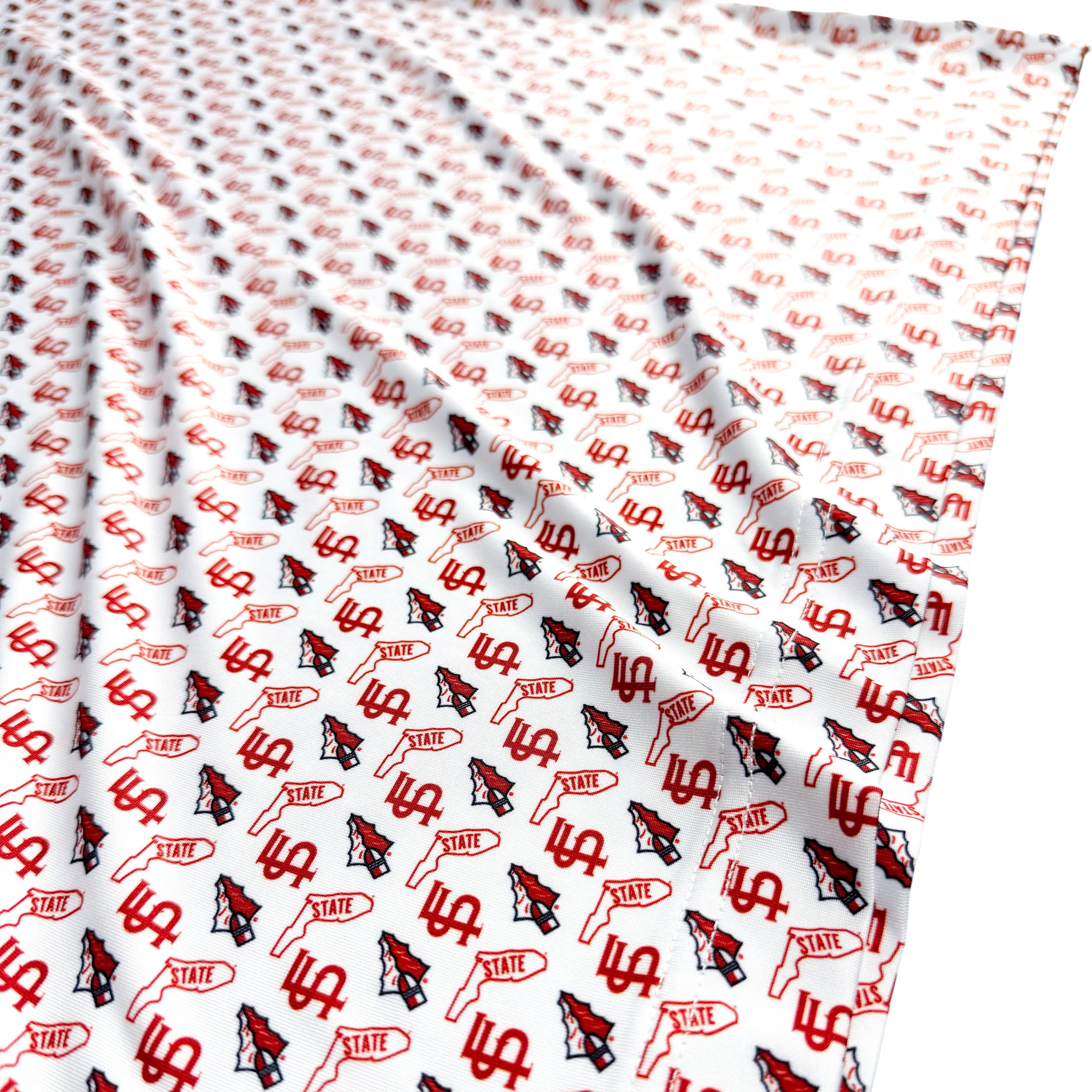 Patterned fabric with red and black designs on a white background