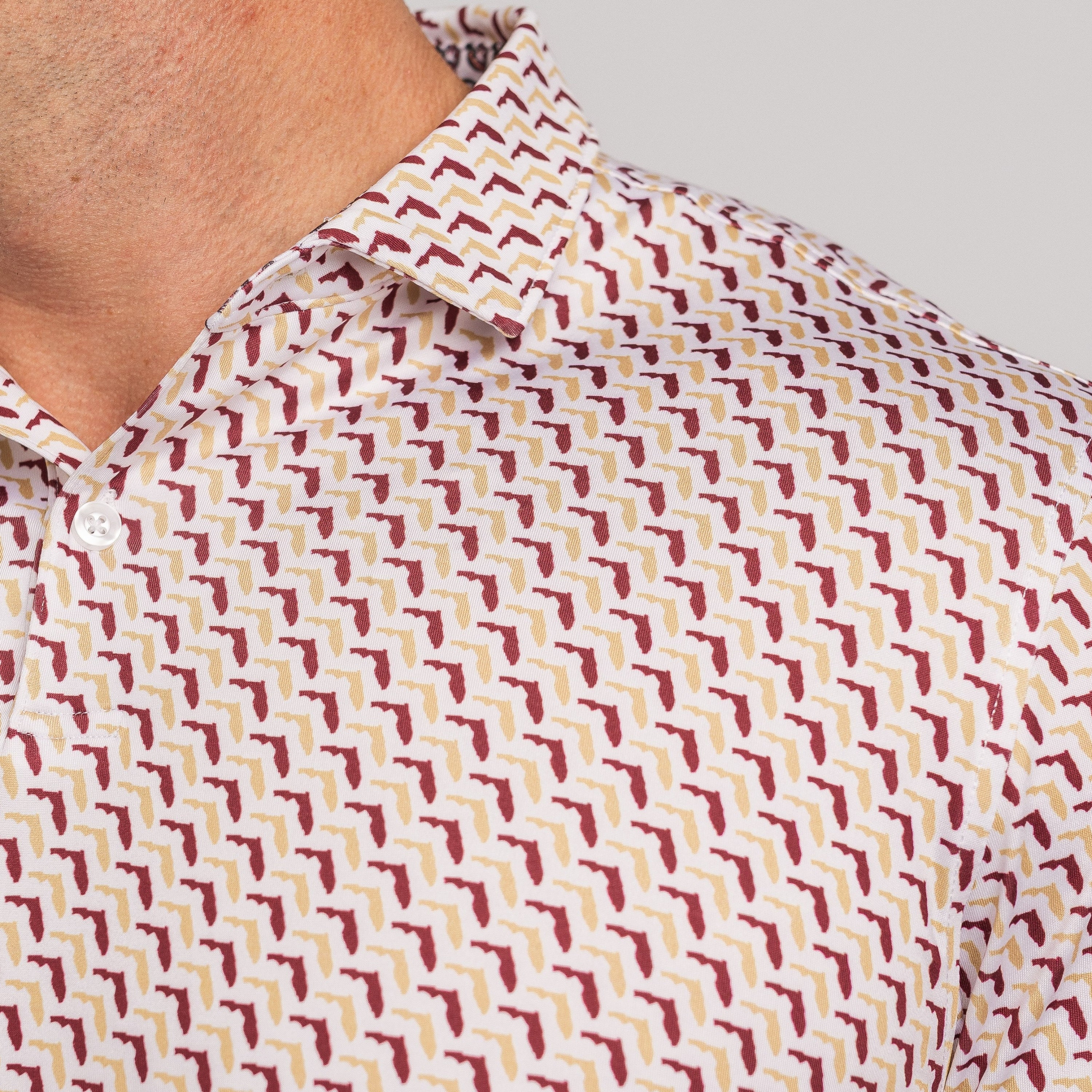Close-up of a patterned shirt with small Floridas on a plain background