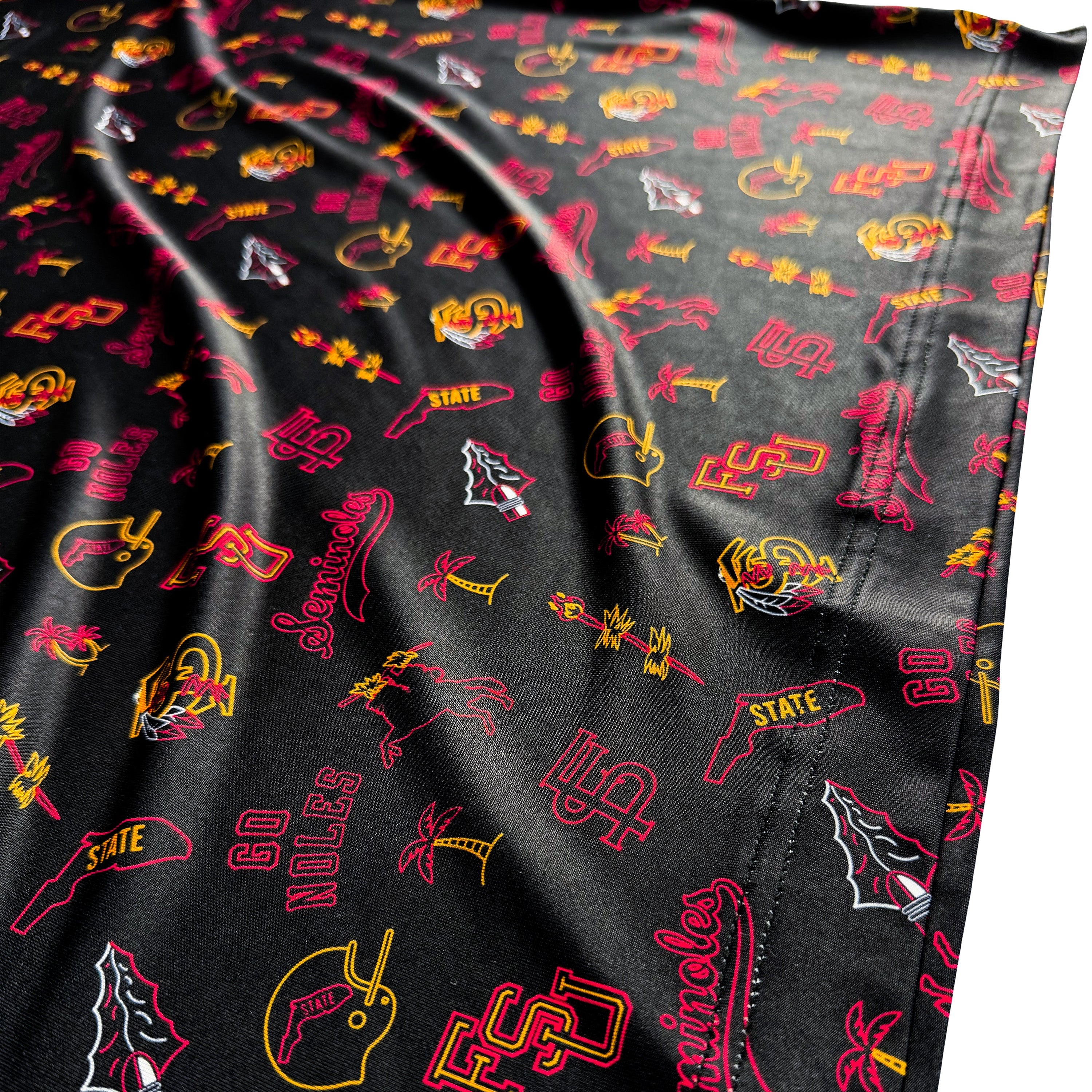 Black fabric with colorful logos and text patterns