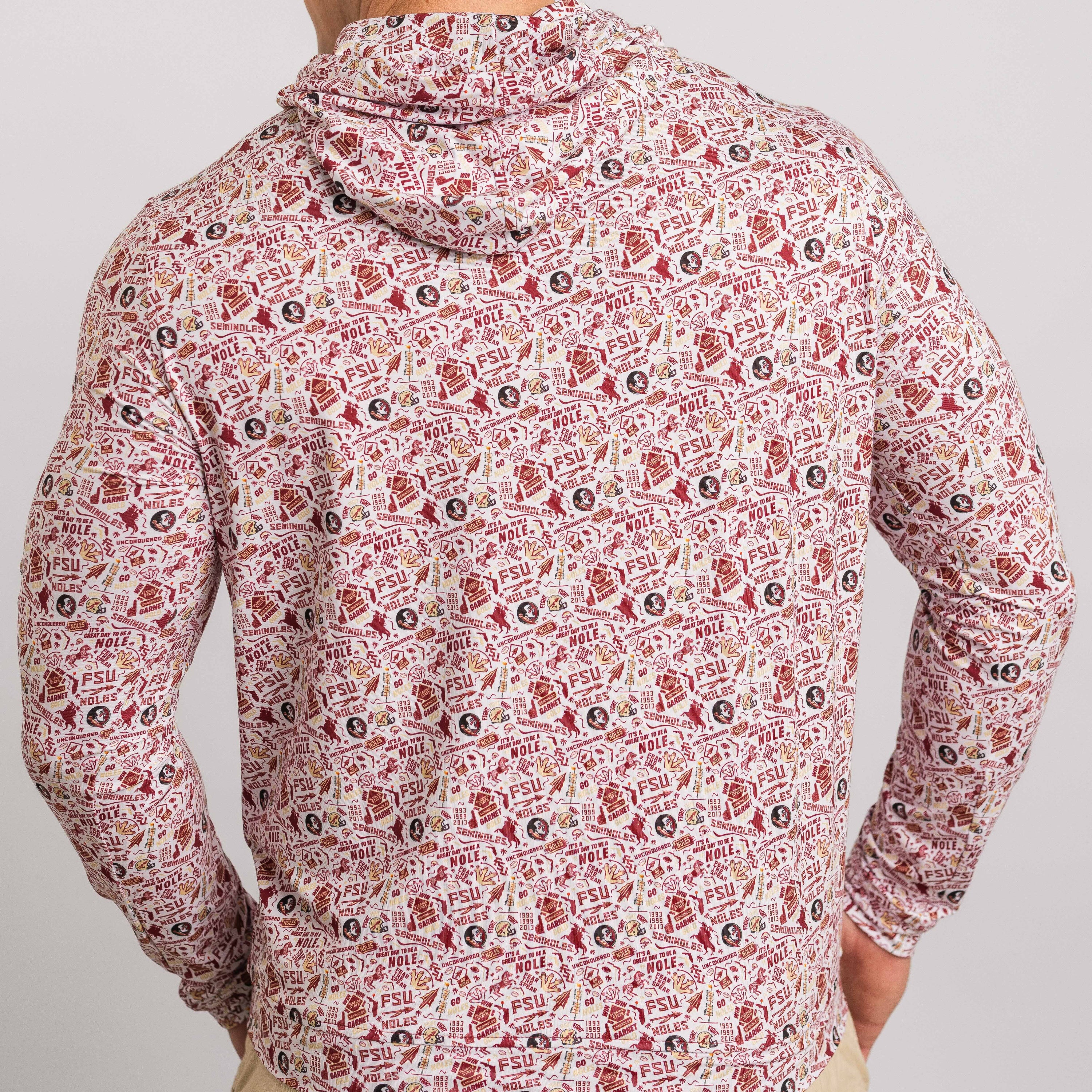 Person wearing a patterned hoodie with a neutral background