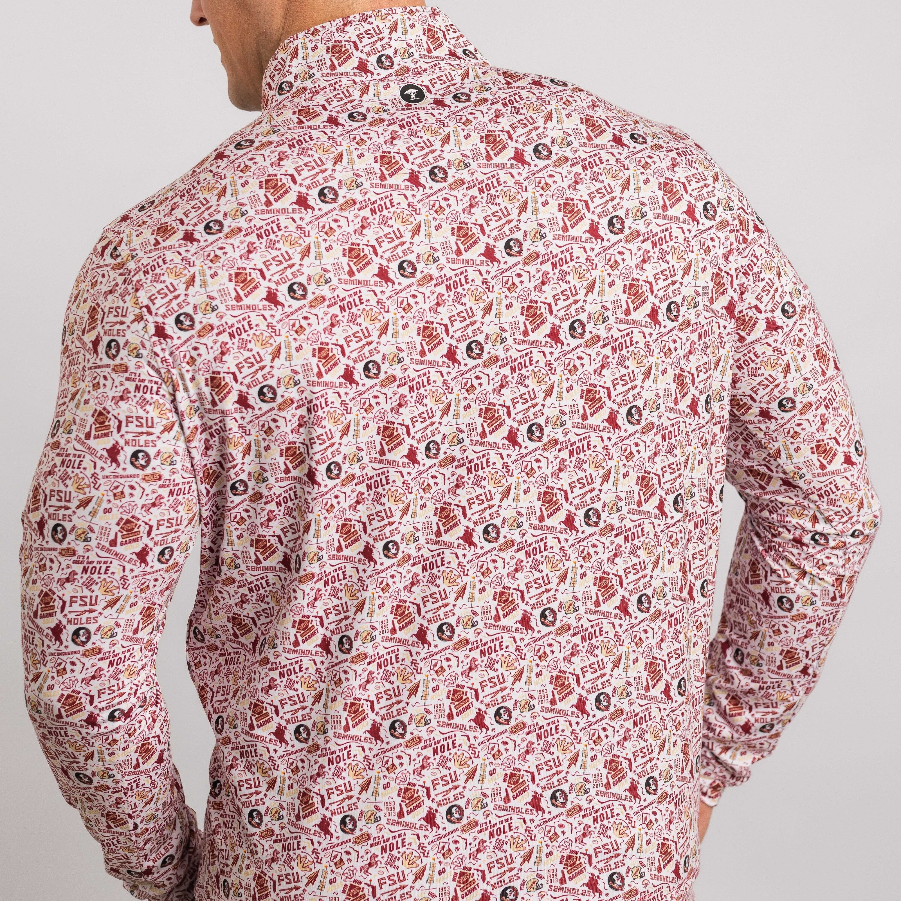 Man wearing a patterned shirt with a neutral background