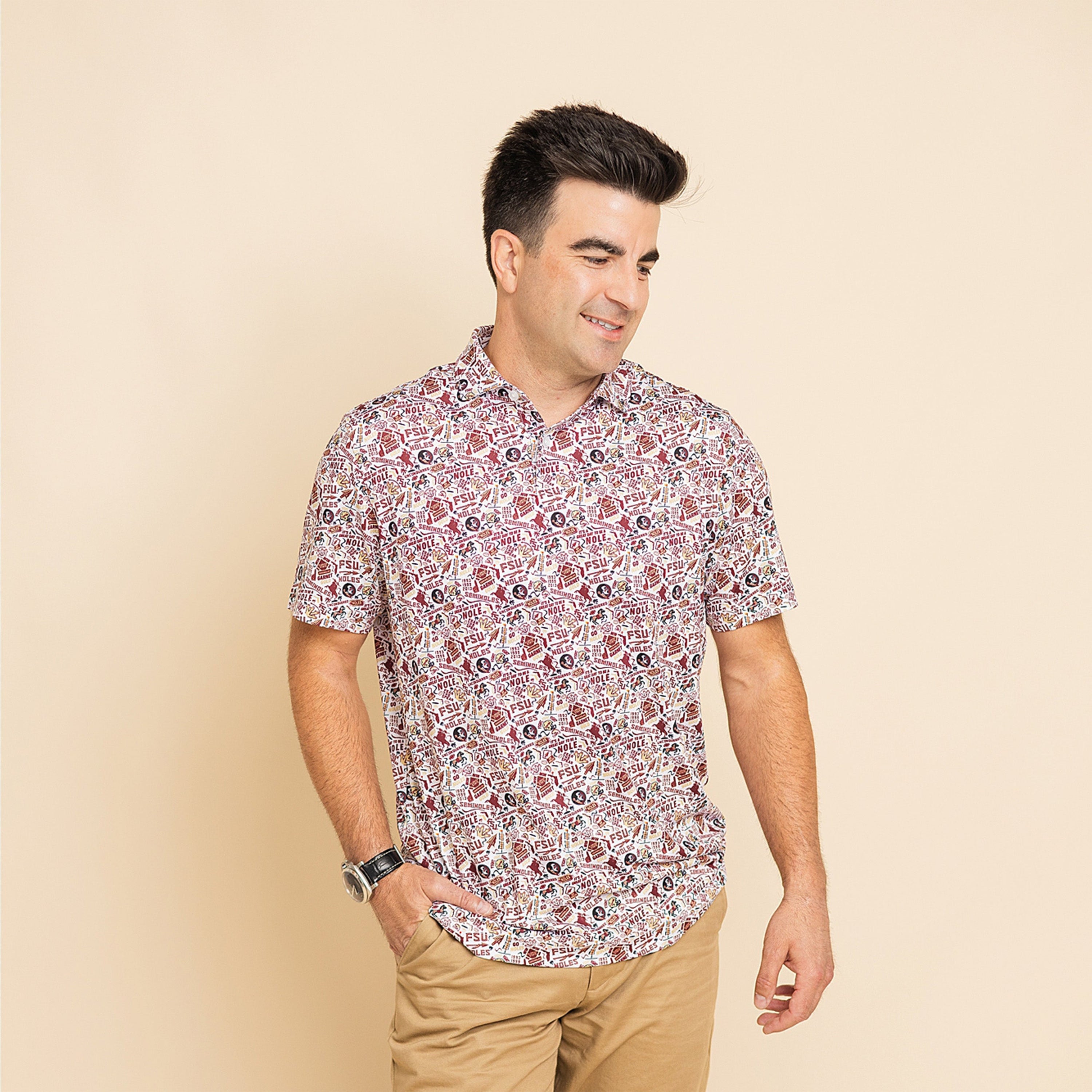 Man wearing a patterned shirt and beige pants on a beige background