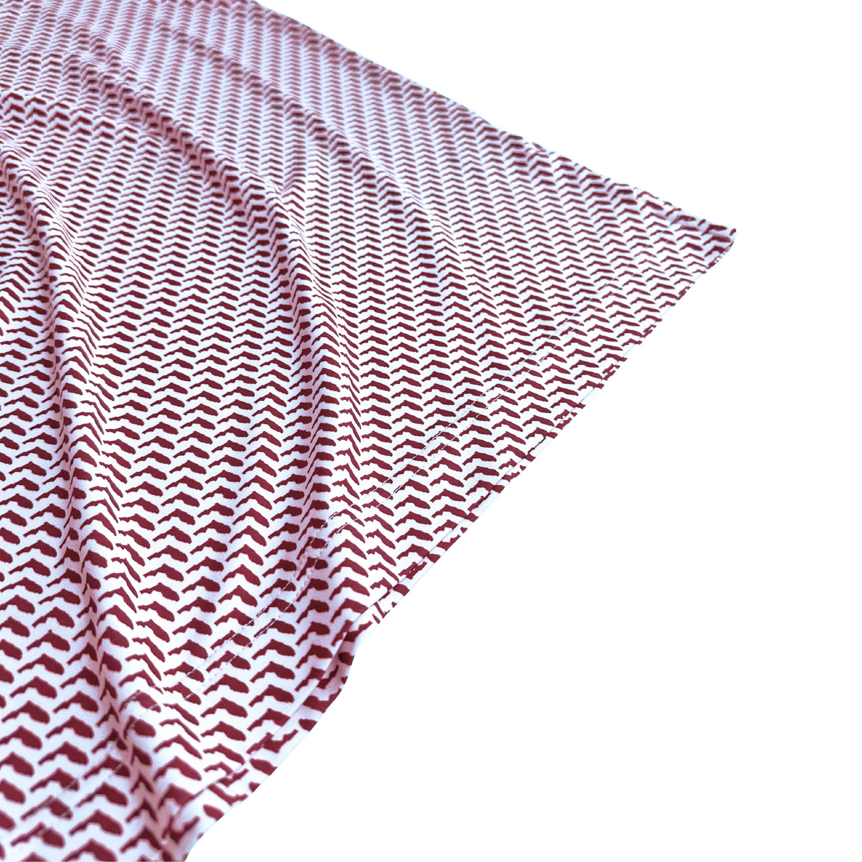 Red and white patterned fabric on a white background