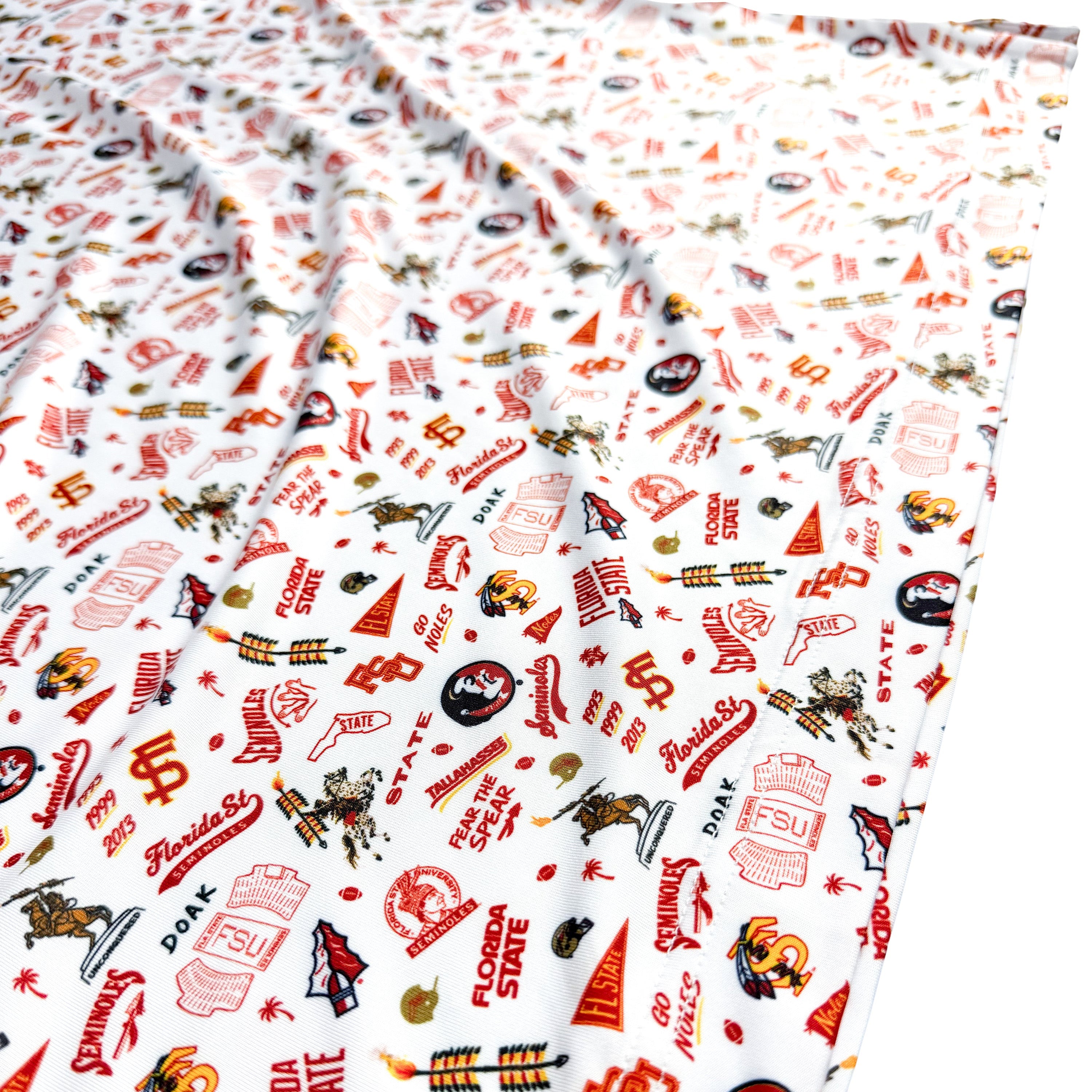 Patterned fabric with red and black designs on a white background