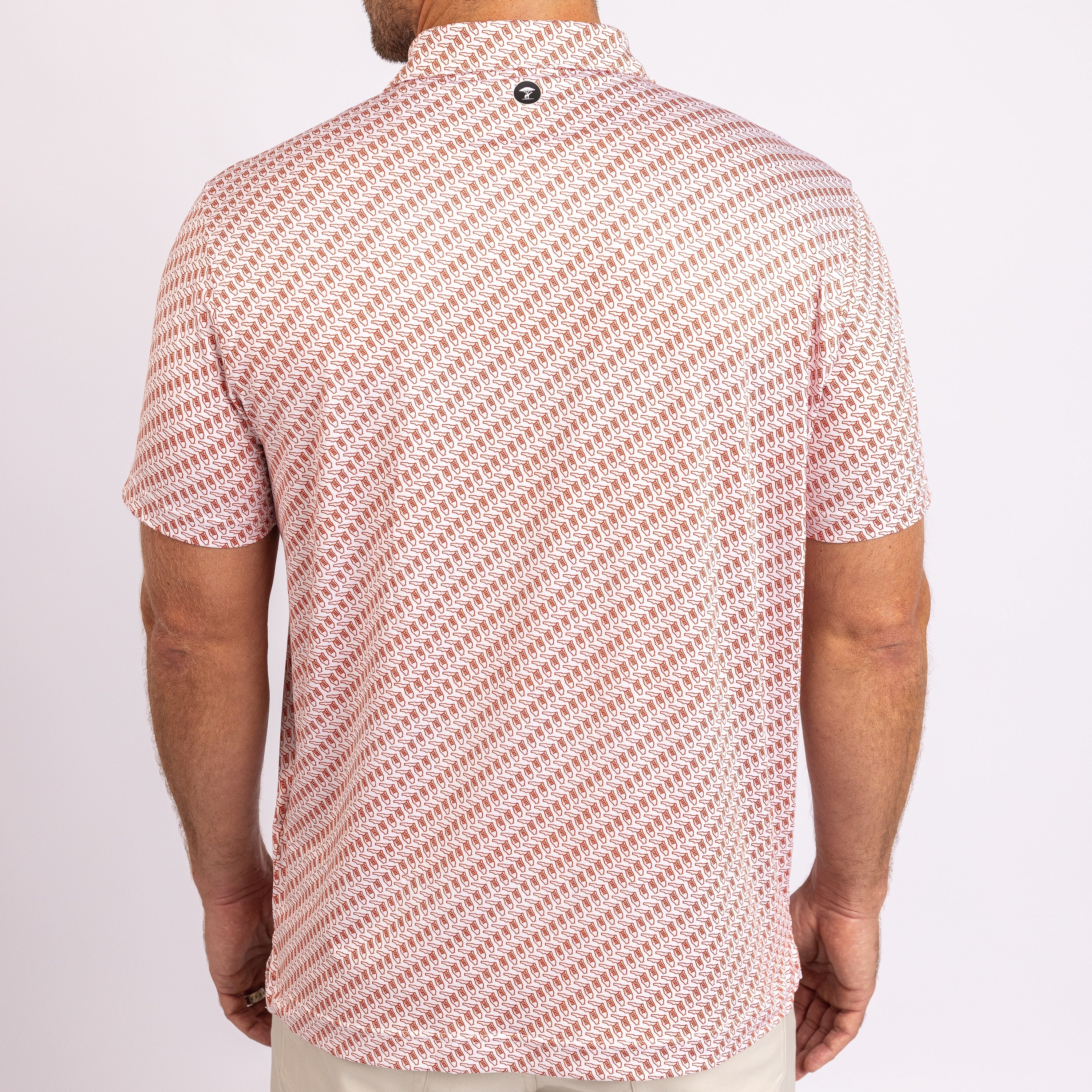 A man viewed from the back wearing a short-sleeve collared shirt with a diagonal repeating pattern.
