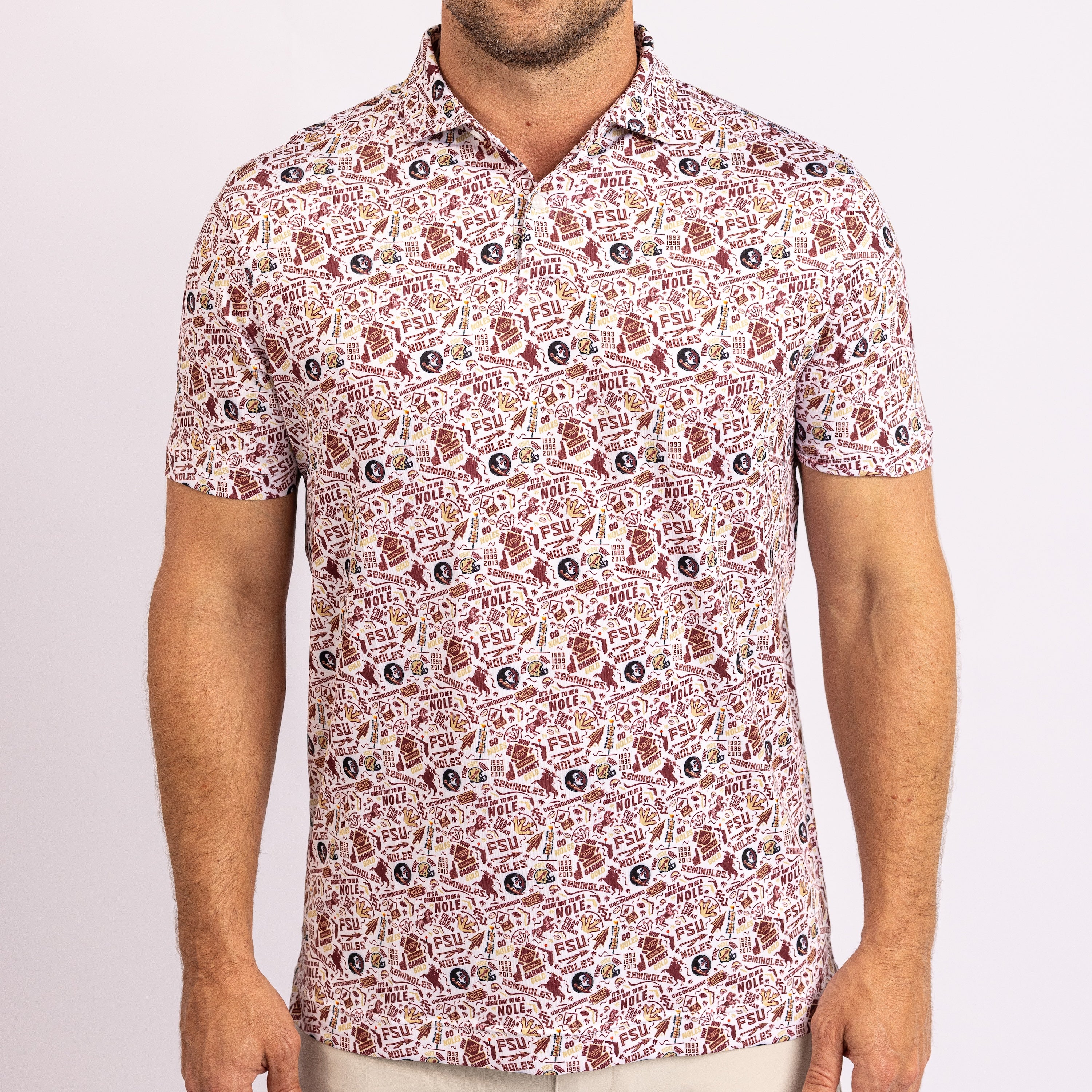 A man wearing a short-sleeve polo shirt with an all-over repeating football-themed pattern in red, brown, black, and beige, photographed against a plain light background.