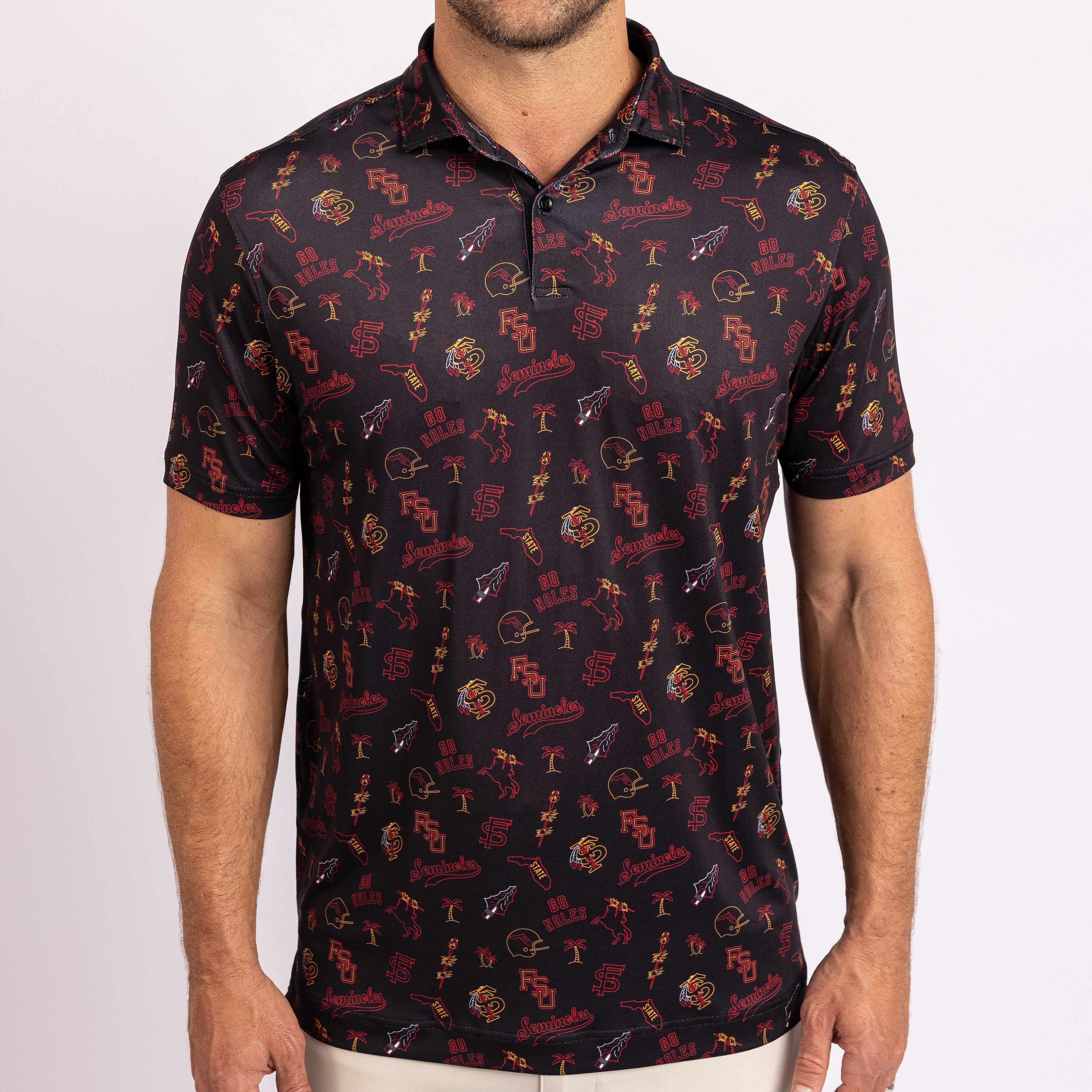 A man wearing a short-sleeve polo shirt with an all-over Florida State University themed print, featuring the FSU logo, Seminole warrior, and 'FSU' text in red, gold, and white on a dark navy background.