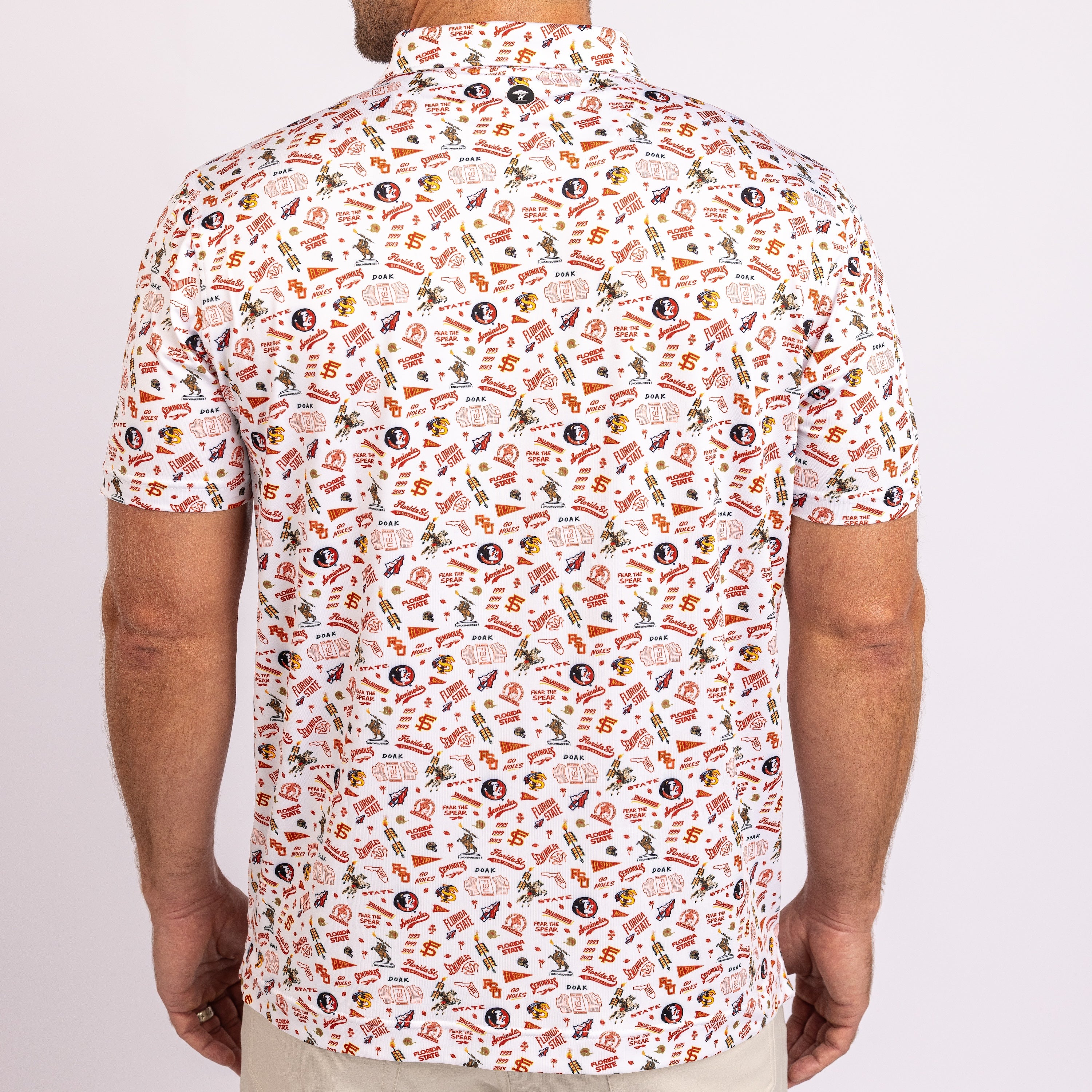 A man viewed from the back wearing a short-sleeve button-up polo