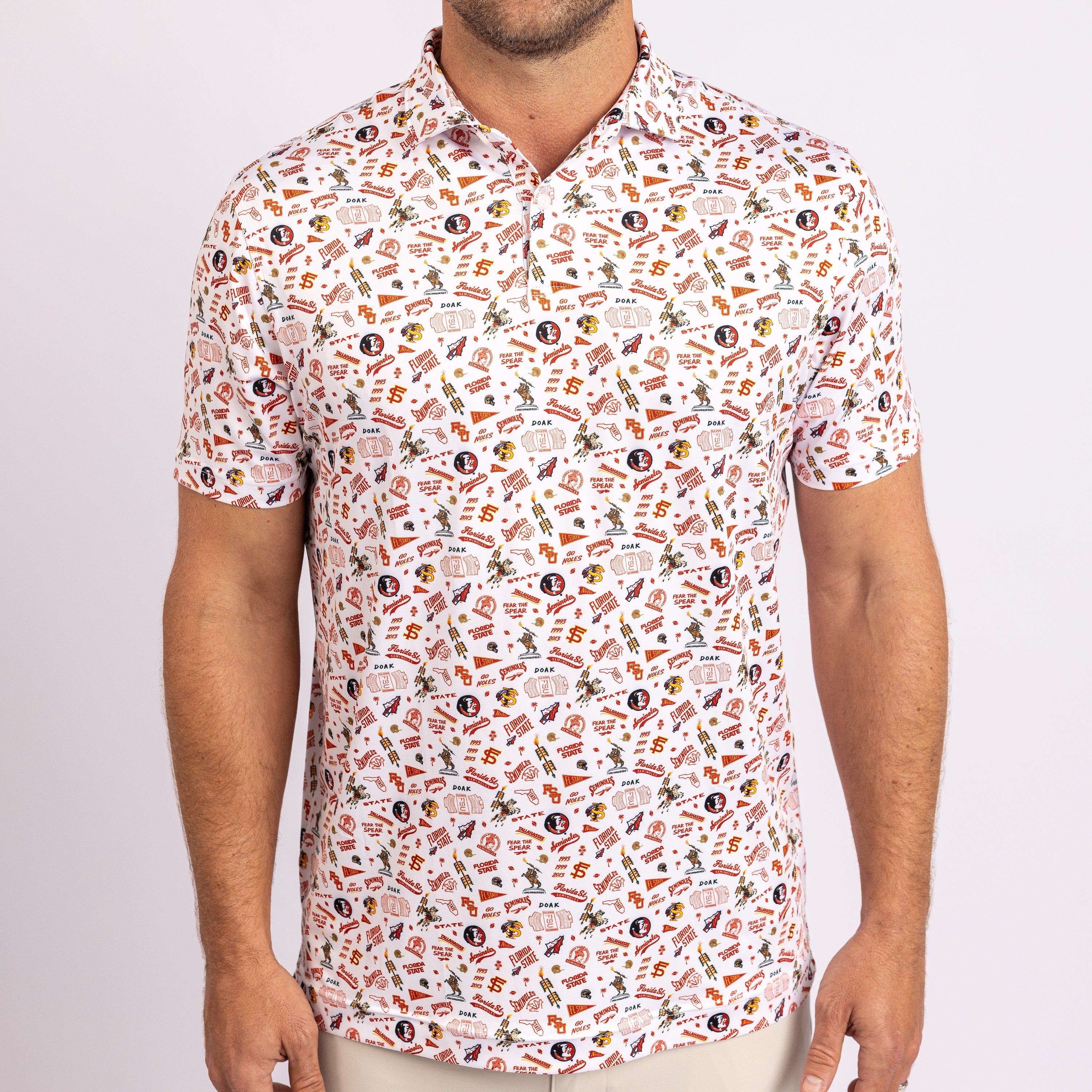 A man wearing a short-sleeve polo shirt with an all-over novelty print featuring various logos