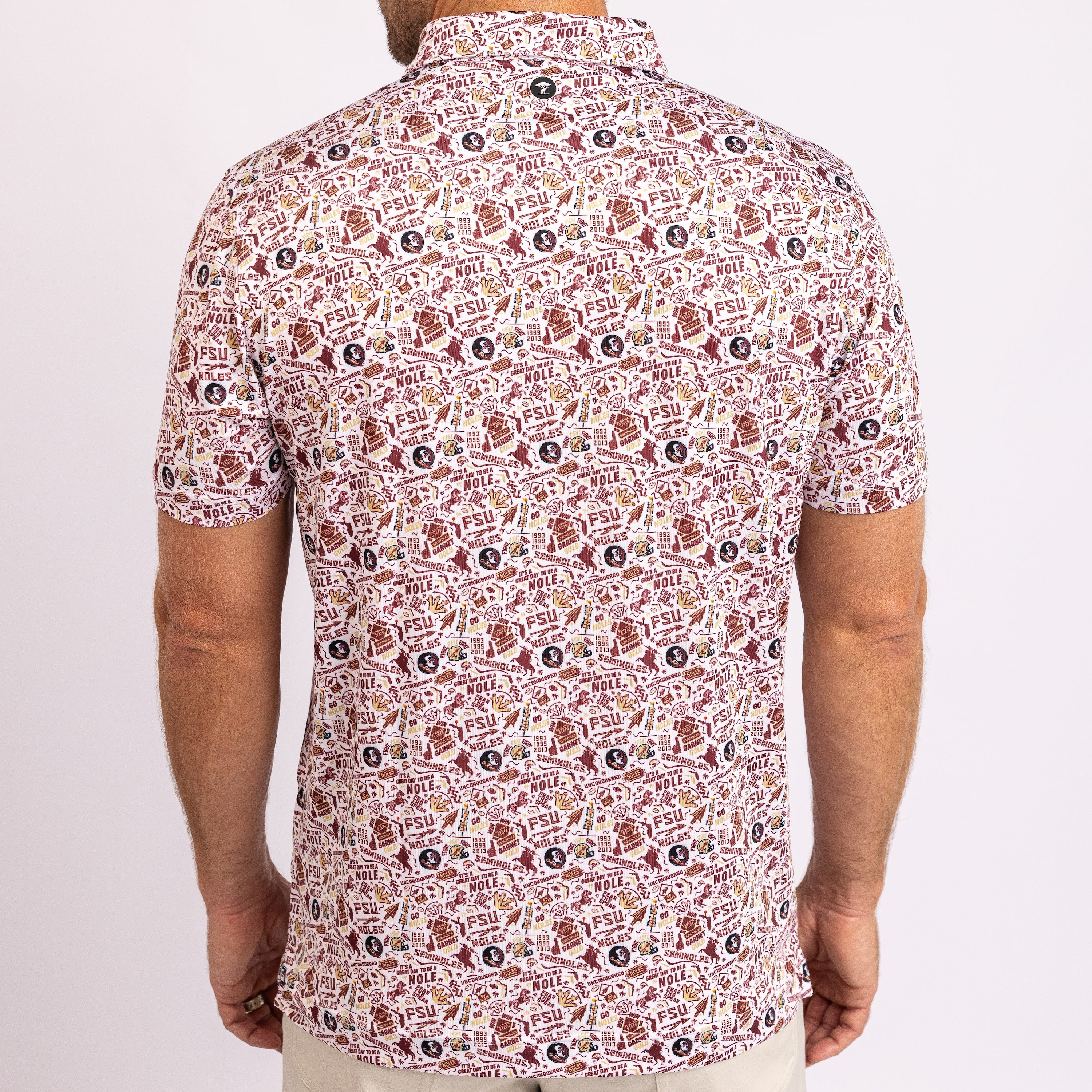 A man wearing a short-sleeve button-up shirt with an all-over repeating