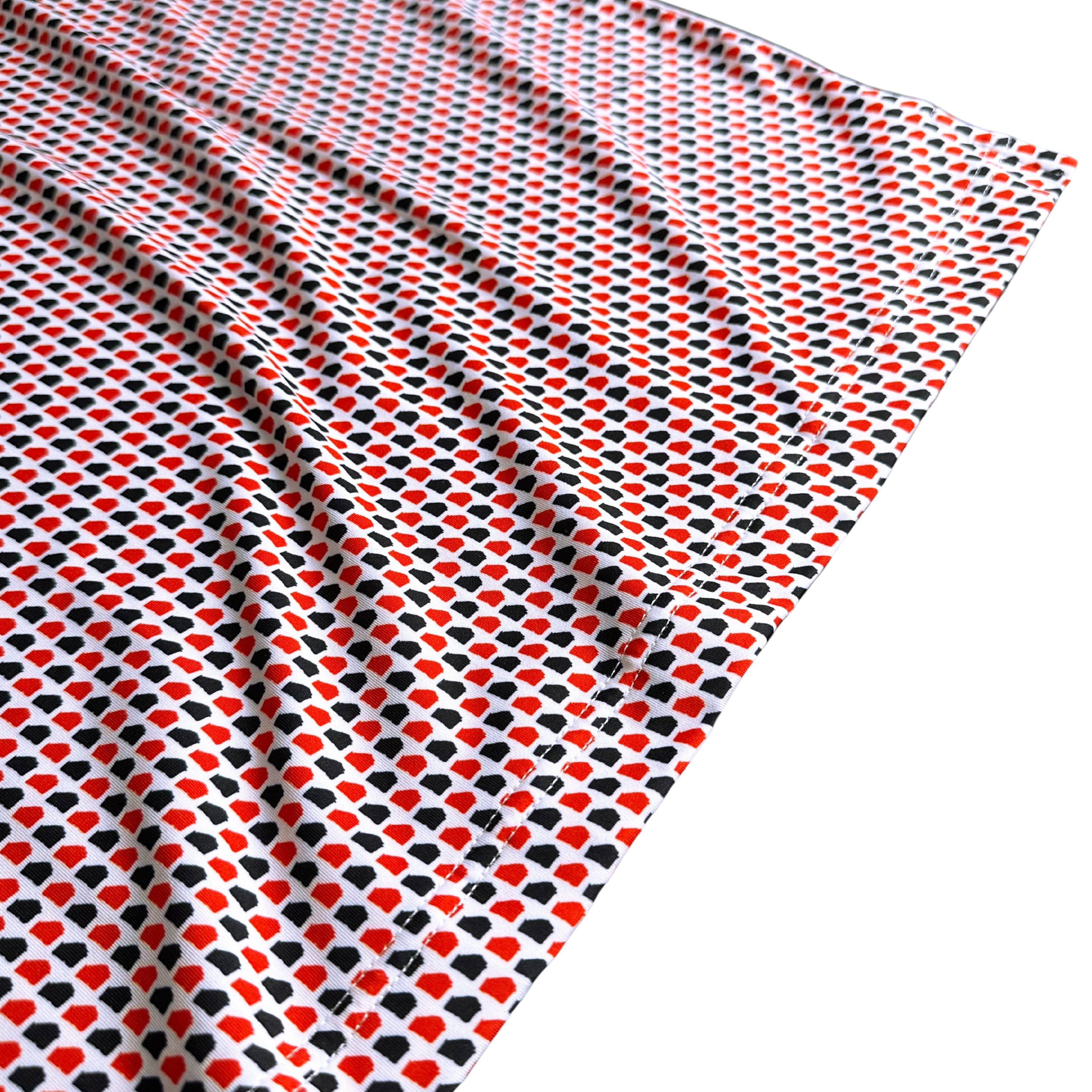 Fabric with red and black pattern on a white background