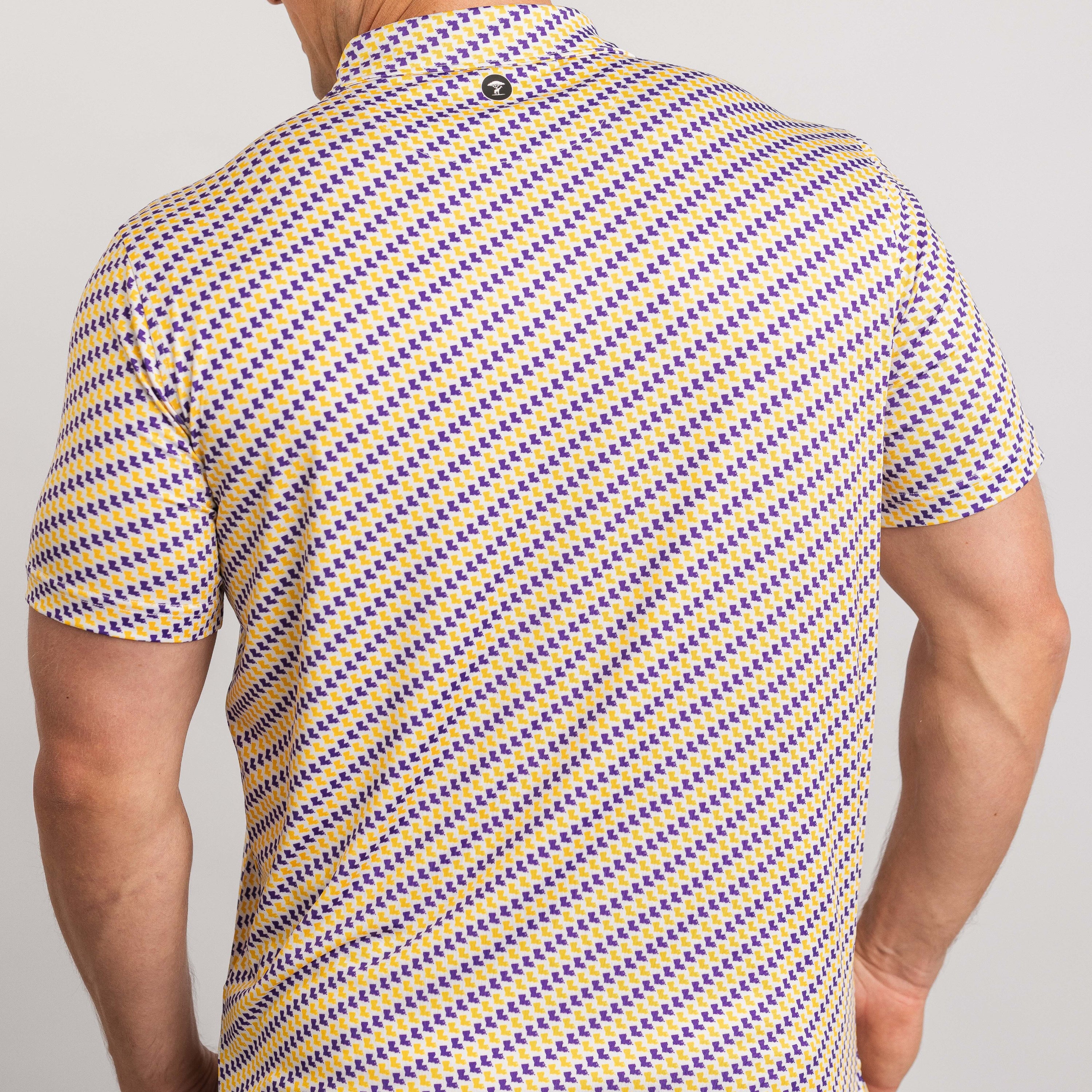 Person wearing a patterned short-sleeve shirt on a plain background