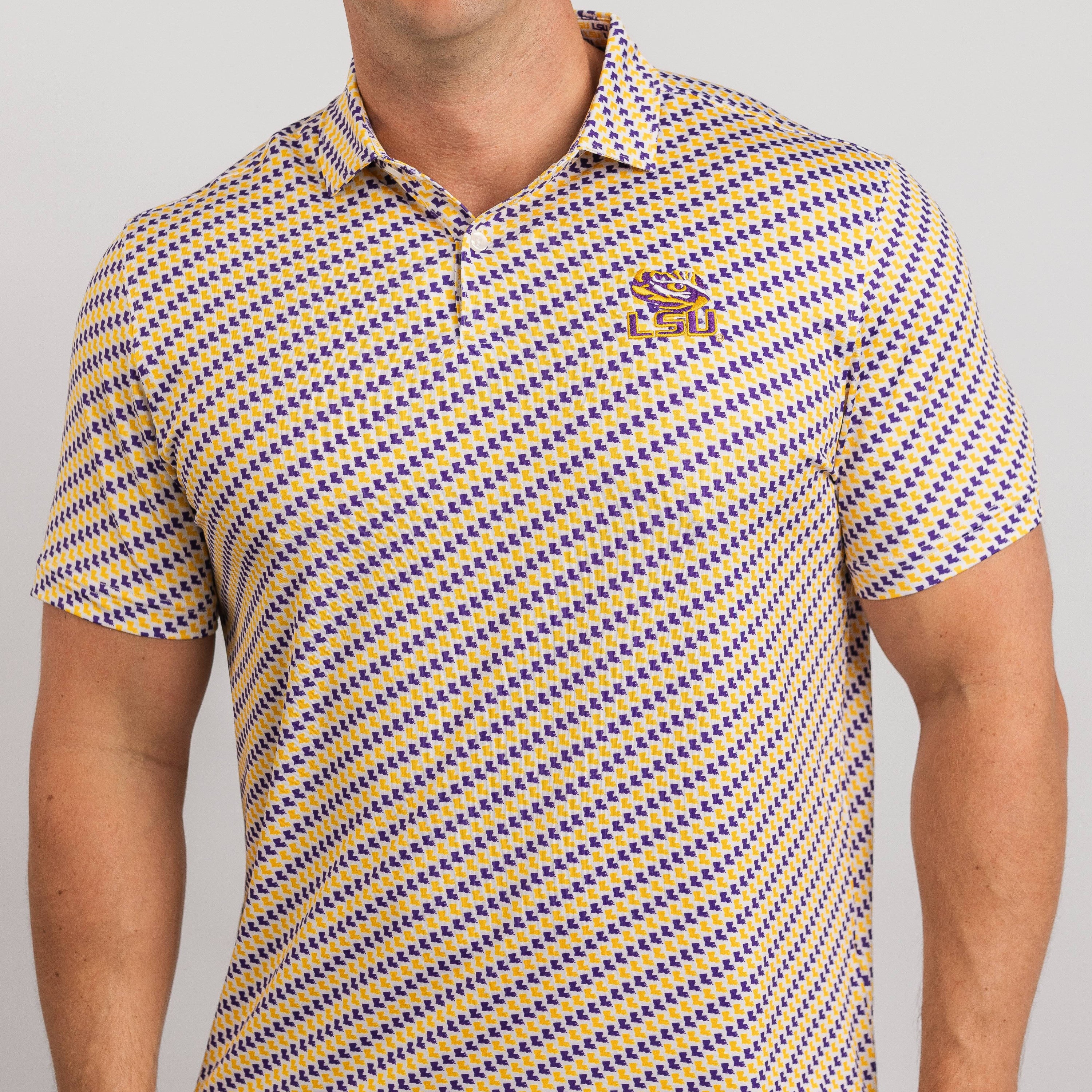 Man wearing a yellow and blue patterned polo shirt on a gray background