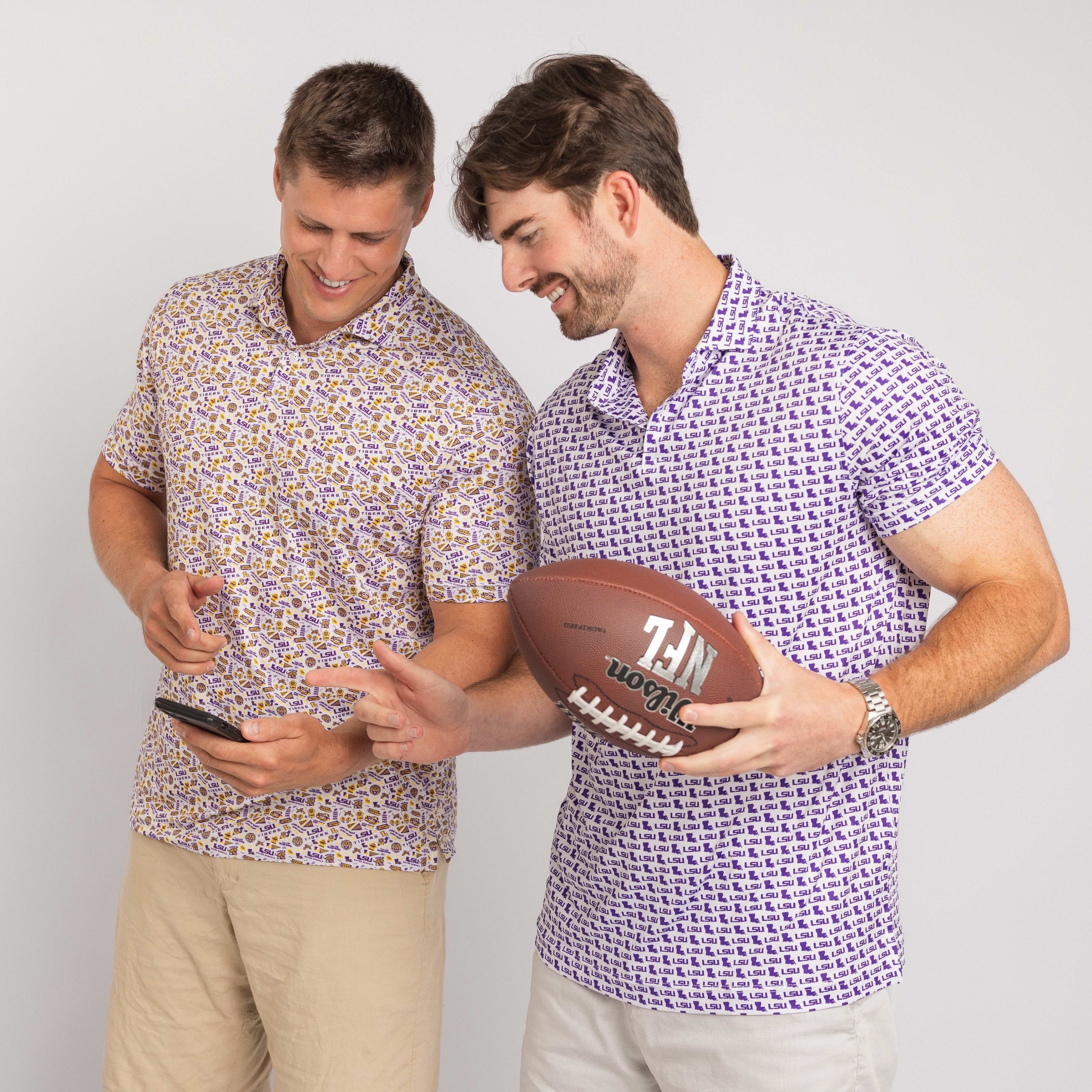 Two men wearing patterned shirts holding a football and a smartphone.