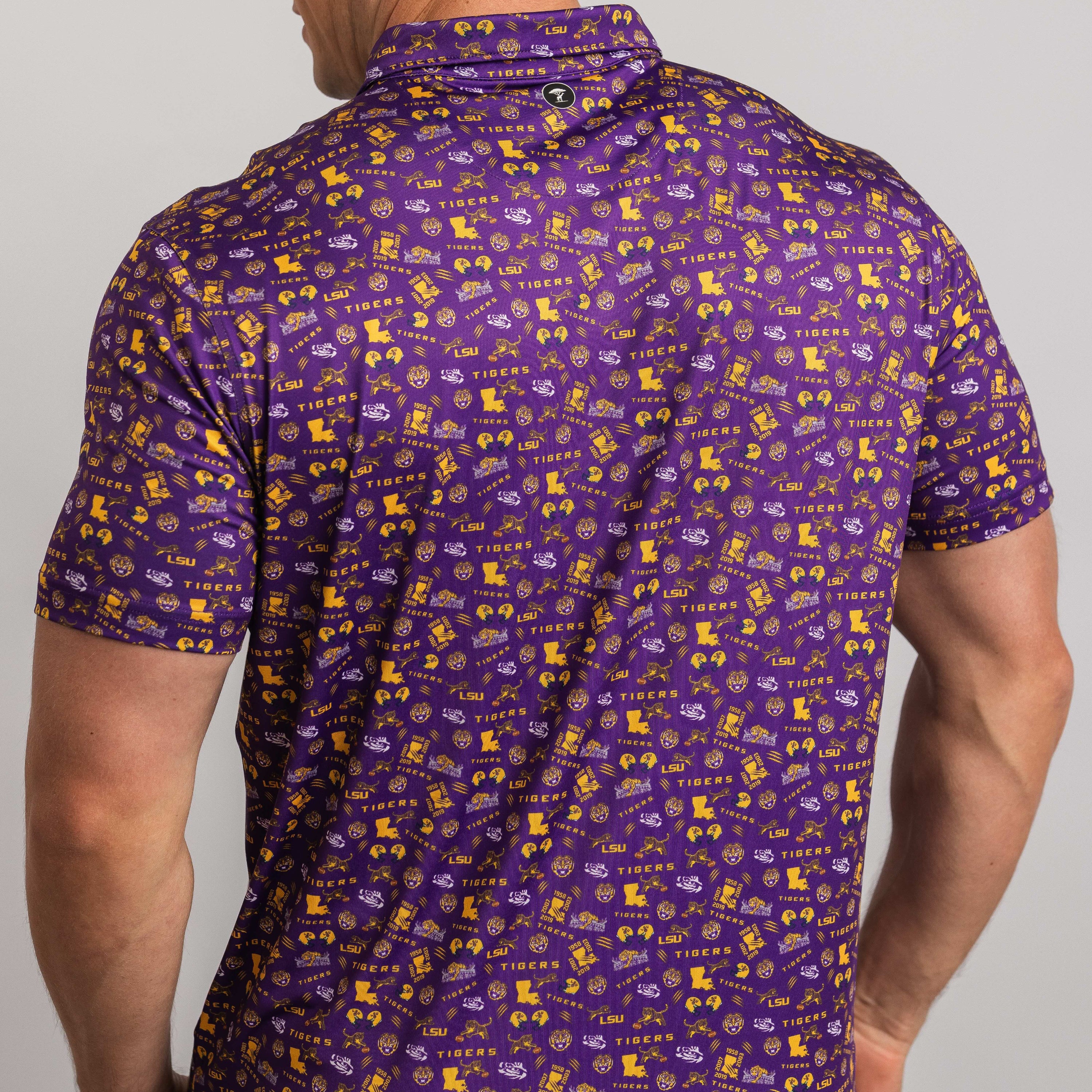Man wearing a purple patterned shirt with yellow graphics on a gray background