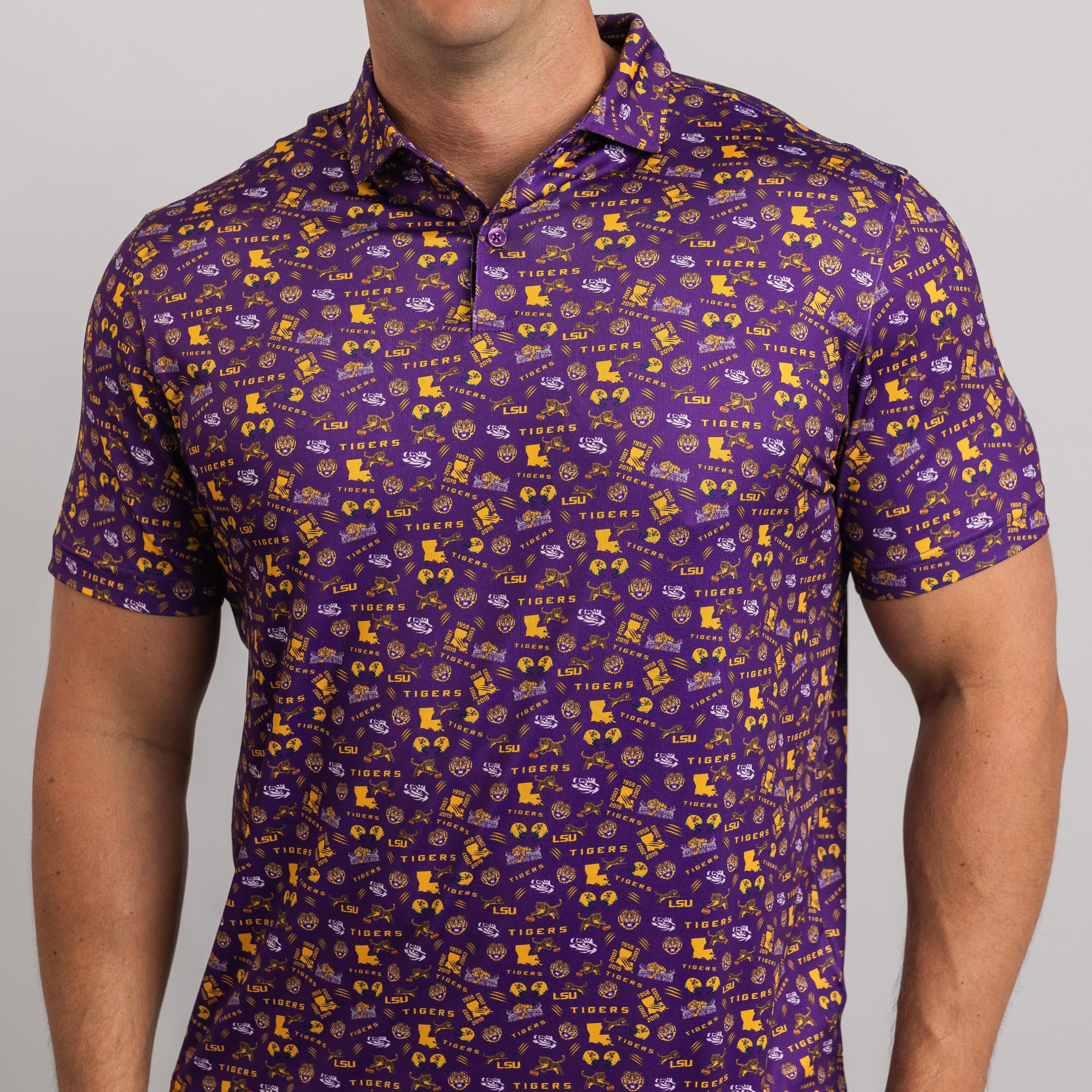 Purple polo shirt with yellow and white patterns worn by a person on a gray background