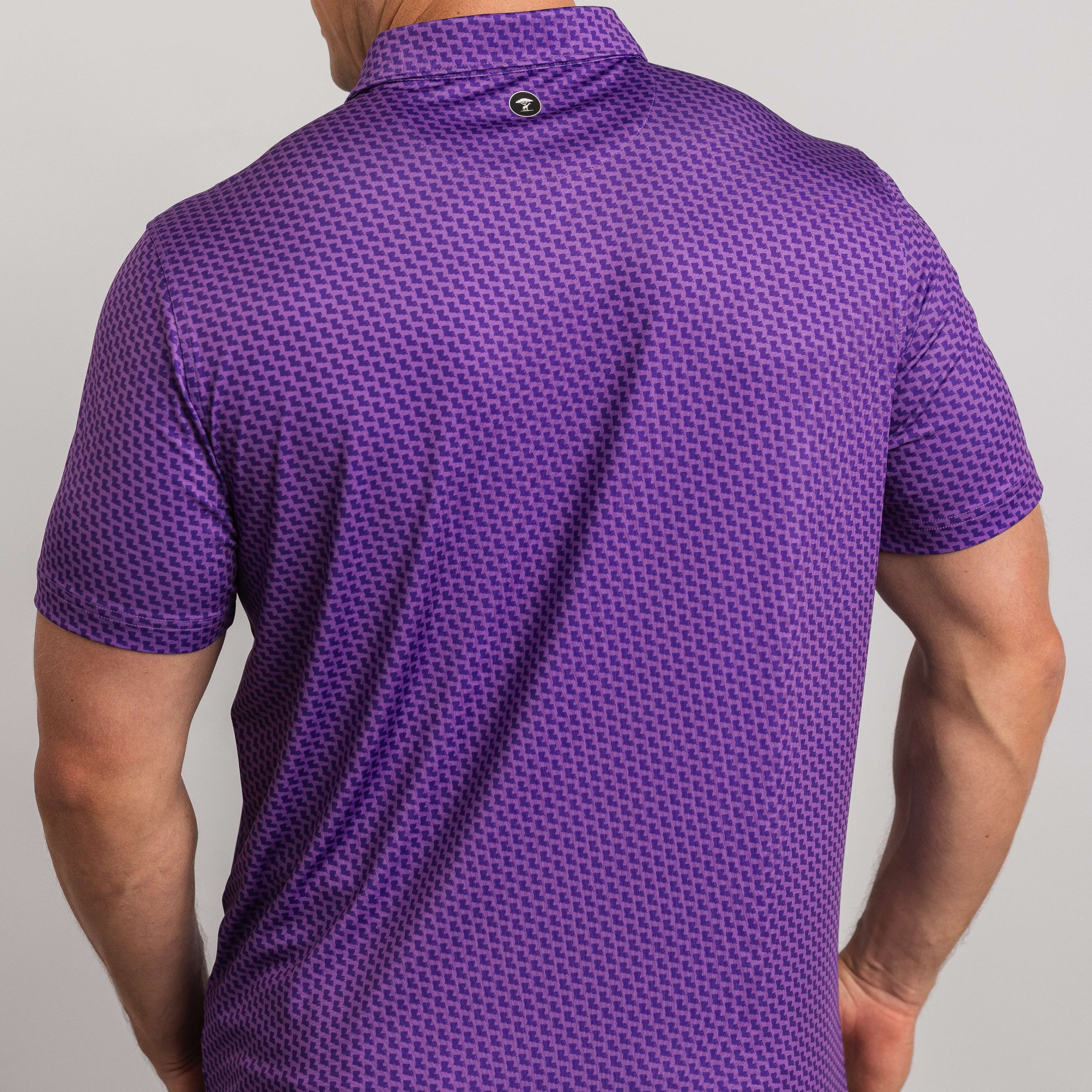 Purple patterned polo shirt worn by a person on a gray background