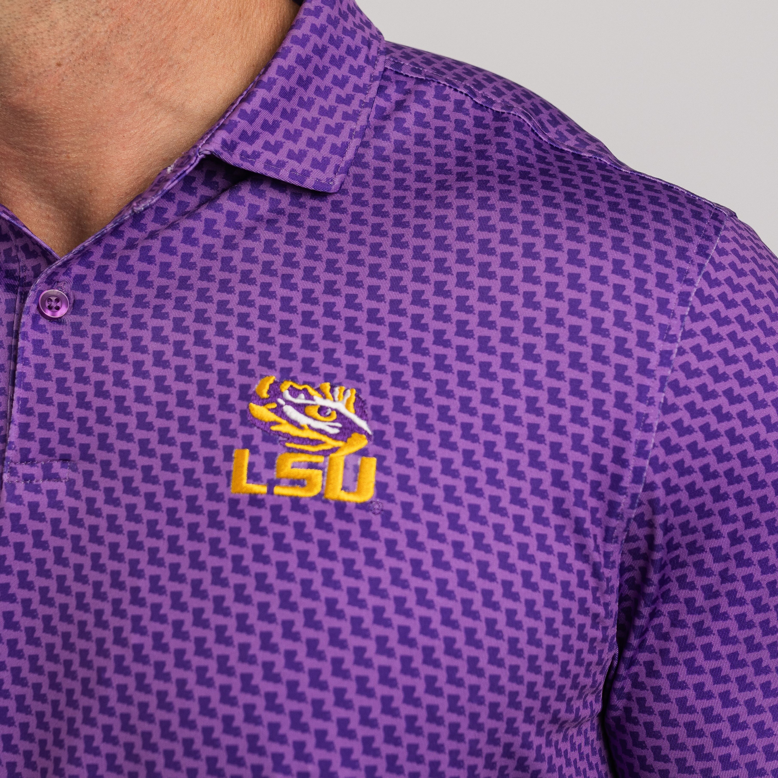 Purple polo shirt with LSU logo on a gray background