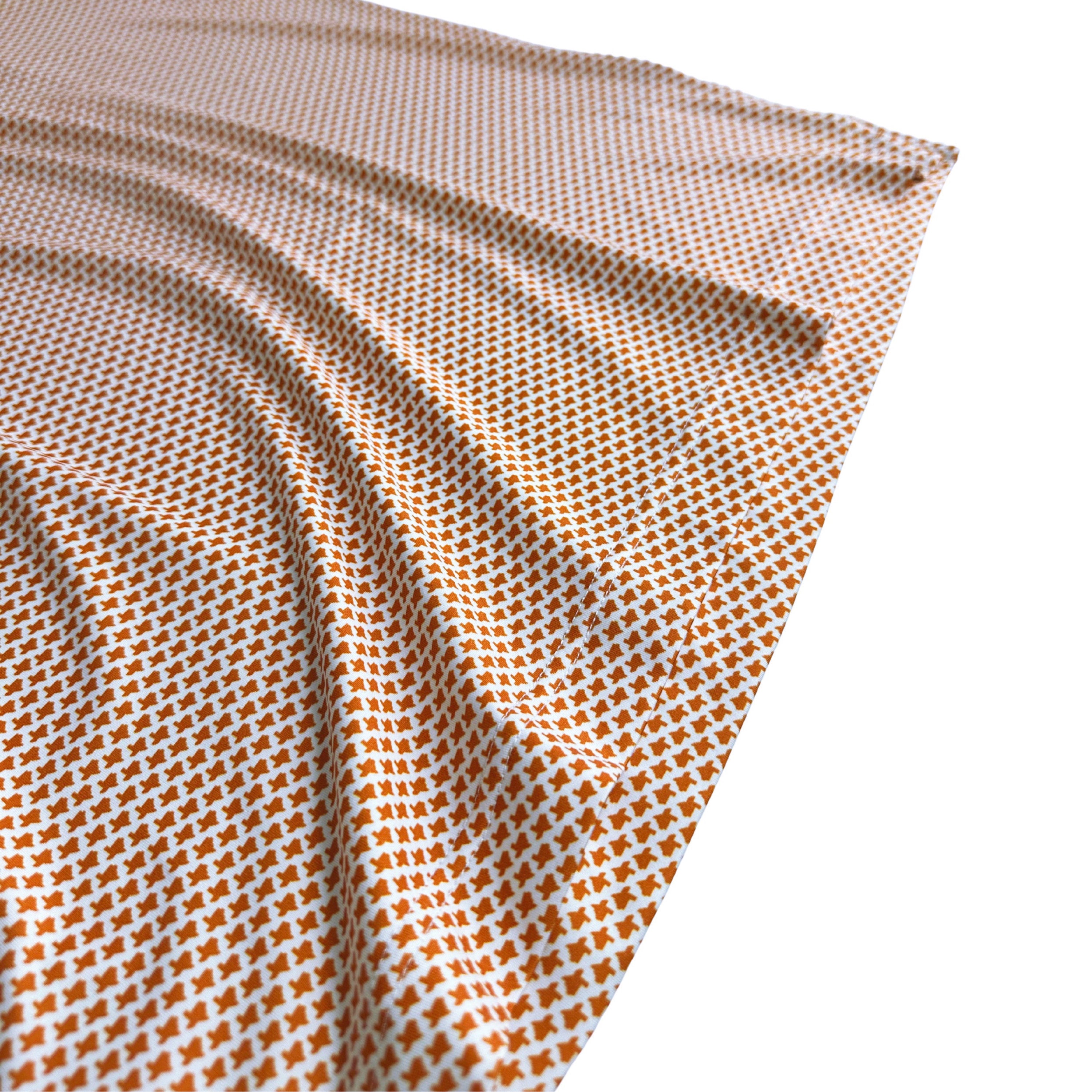 Close-up of a folded fabric with a small pattern on a white background