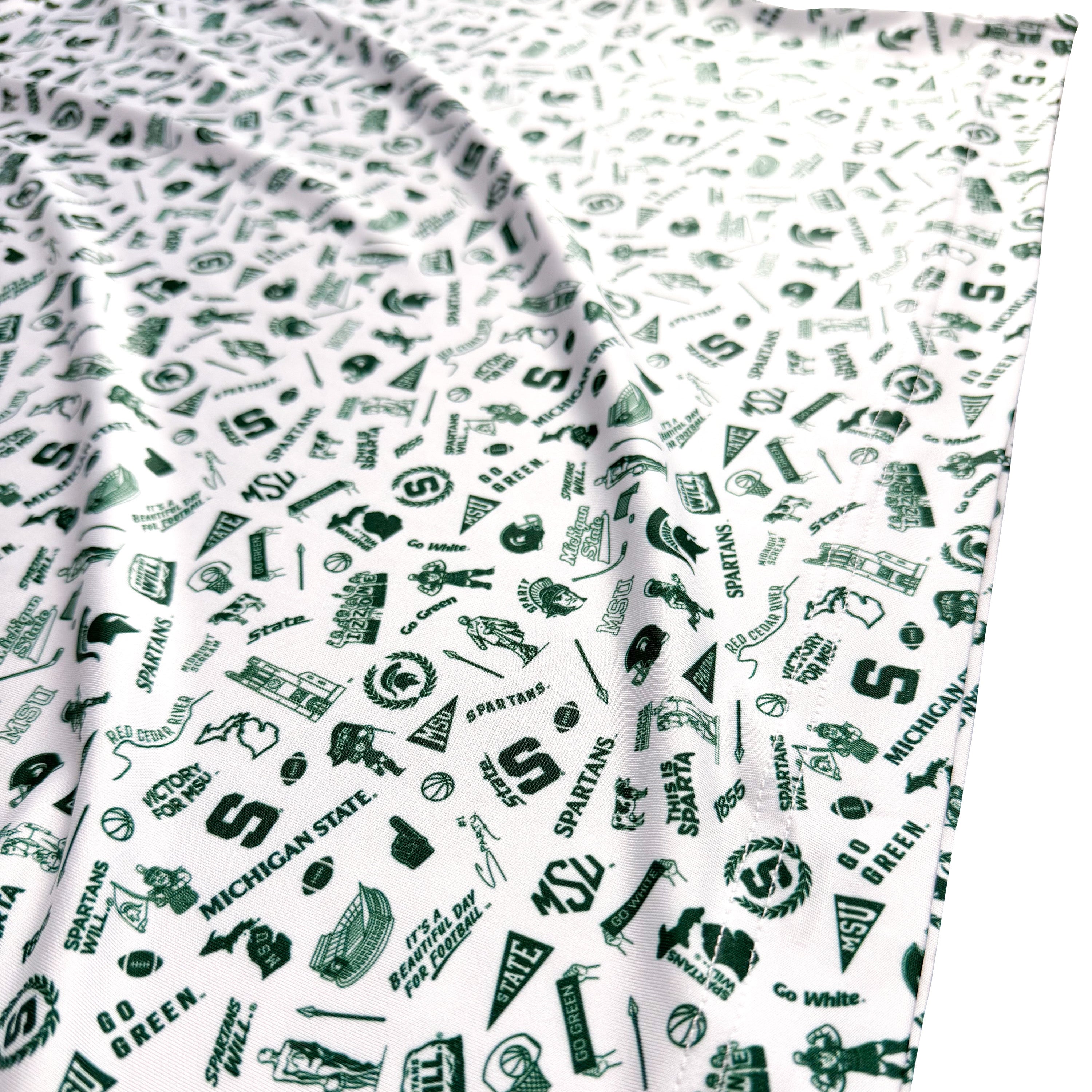Fabric with green and black patterns on a white background