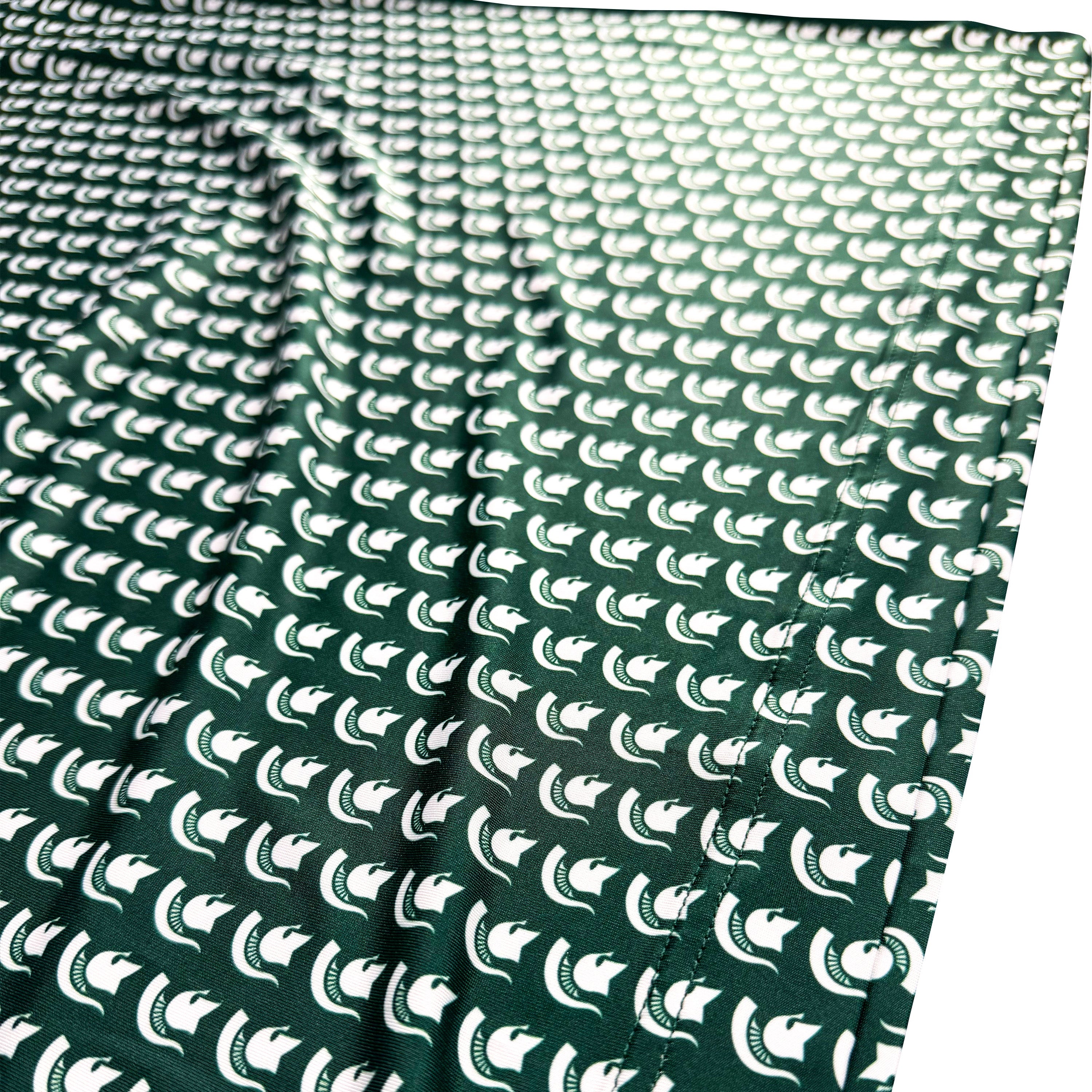 Green fabric with white pattern on a white background