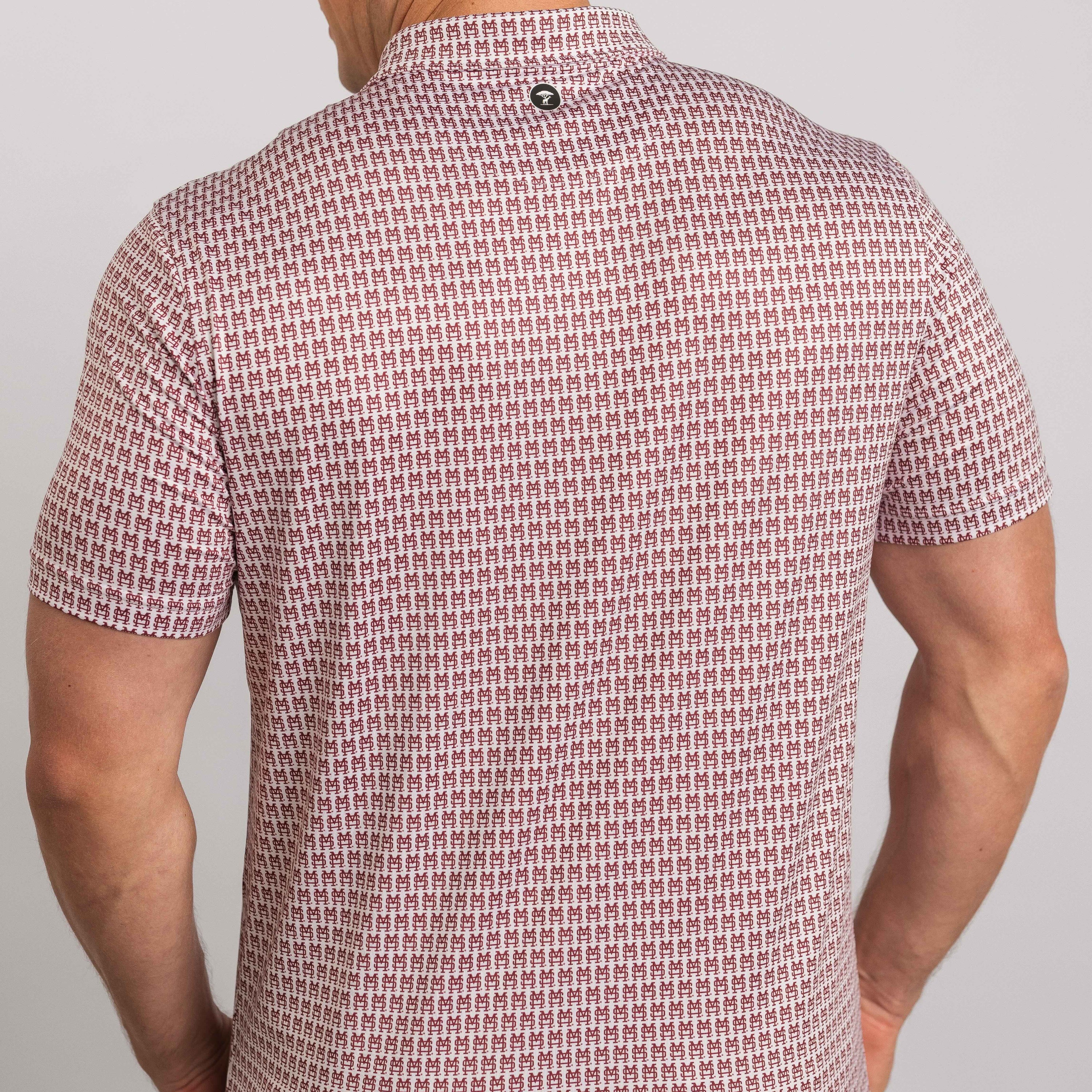 Person wearing a patterned short-sleeve shirt on a plain background