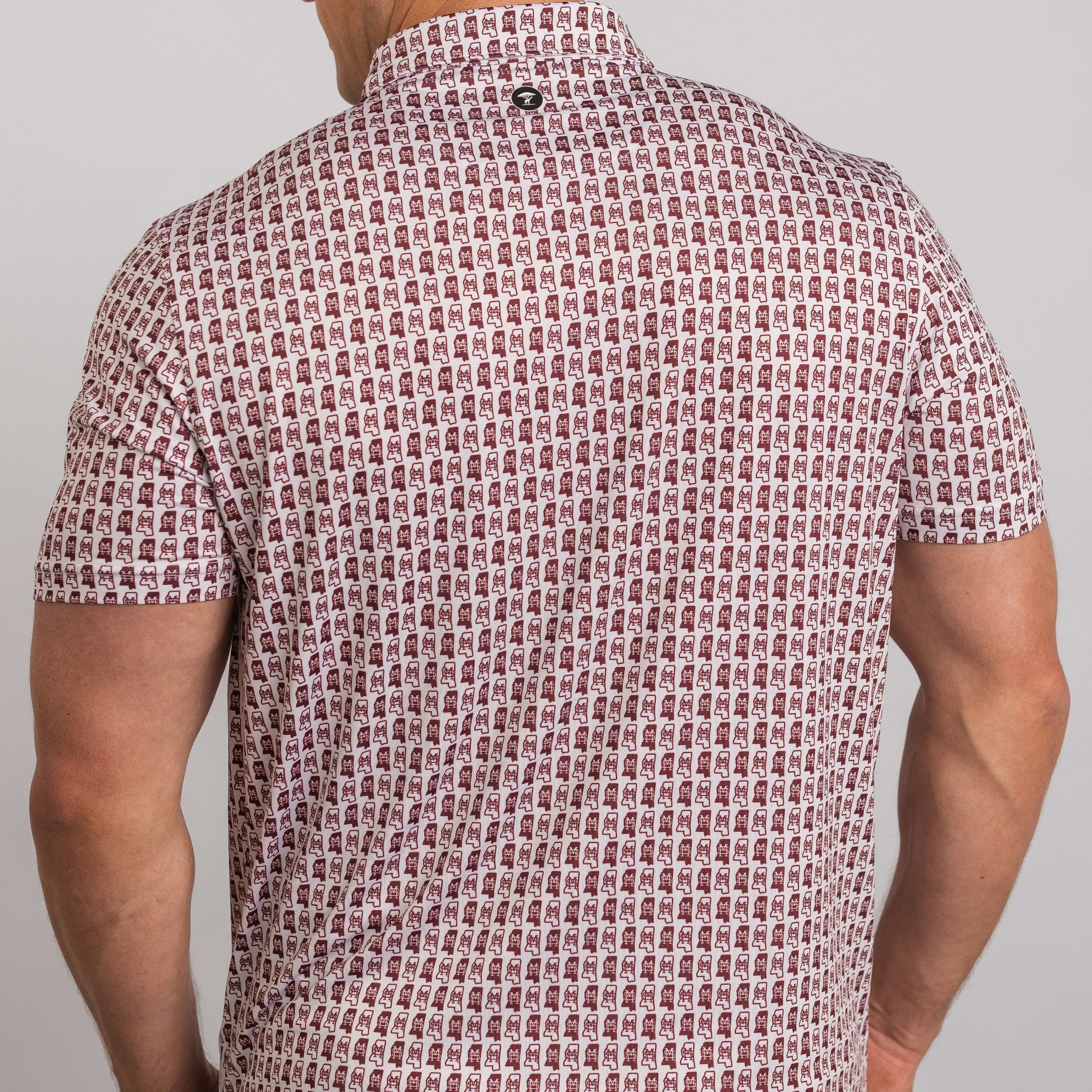 Man wearing a patterned short-sleeve shirt against a plain background