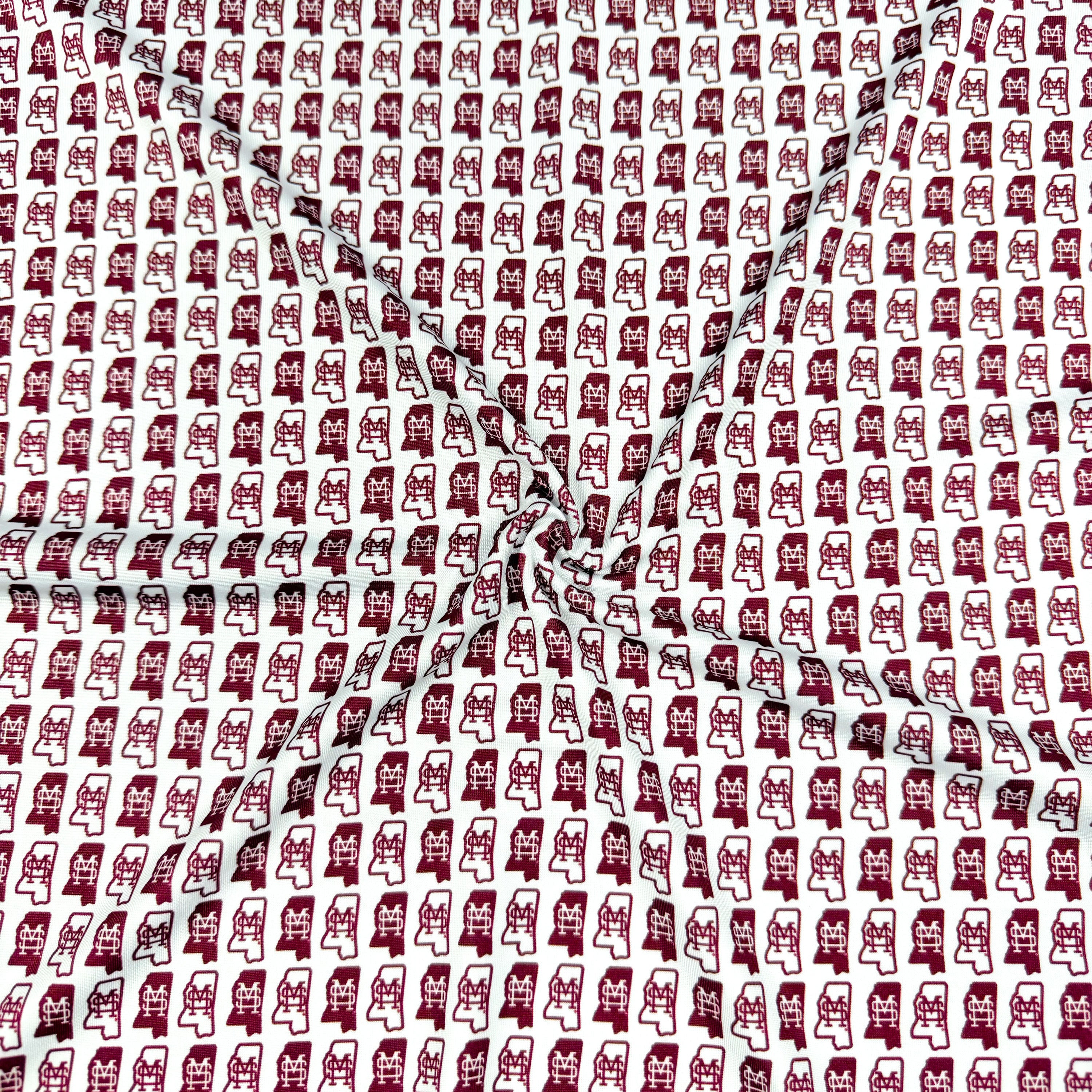 Pattern of red and white shapes on a textured background