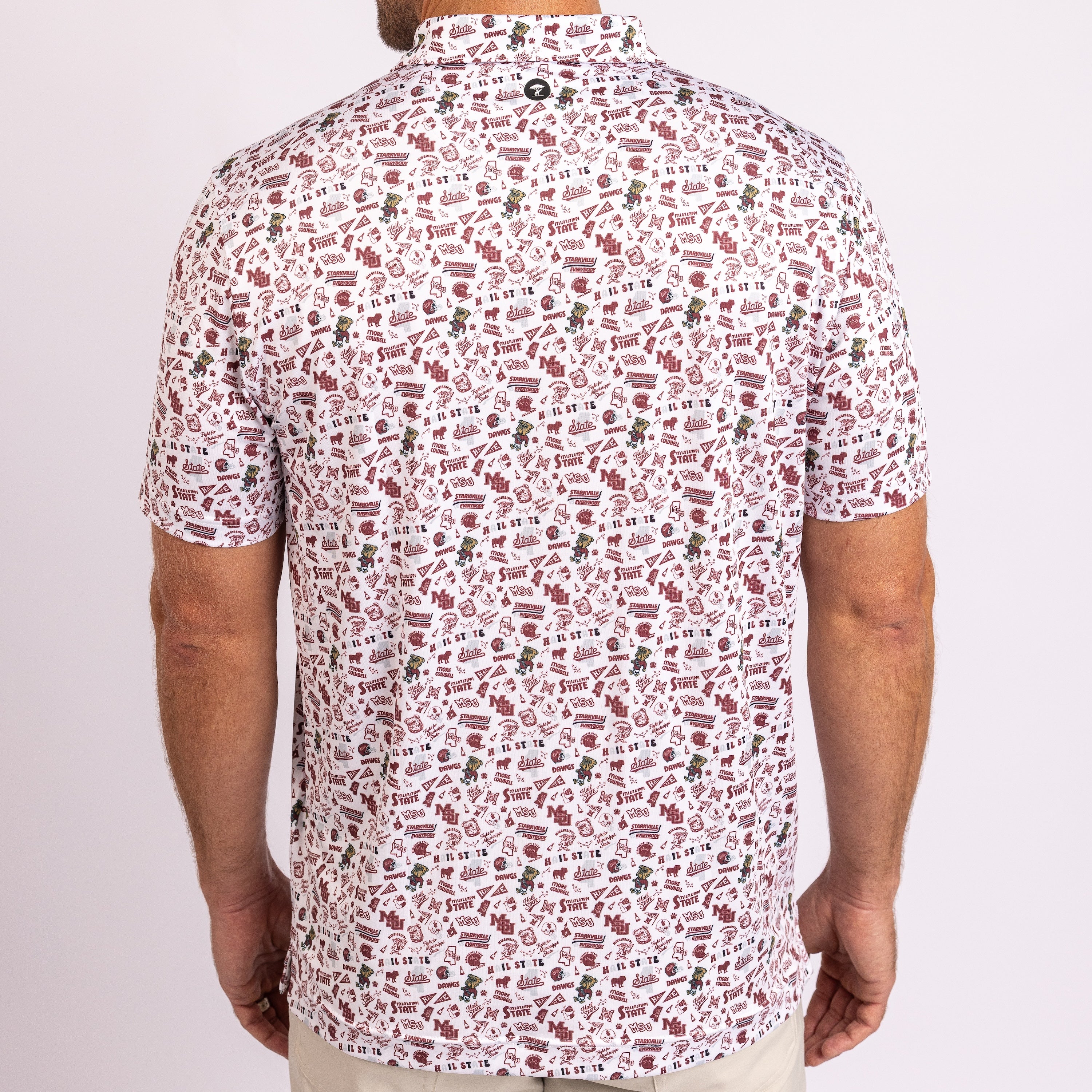 A man viewed from the back wearing a short-sleeve button-up shirt with an all-over dense abstract print