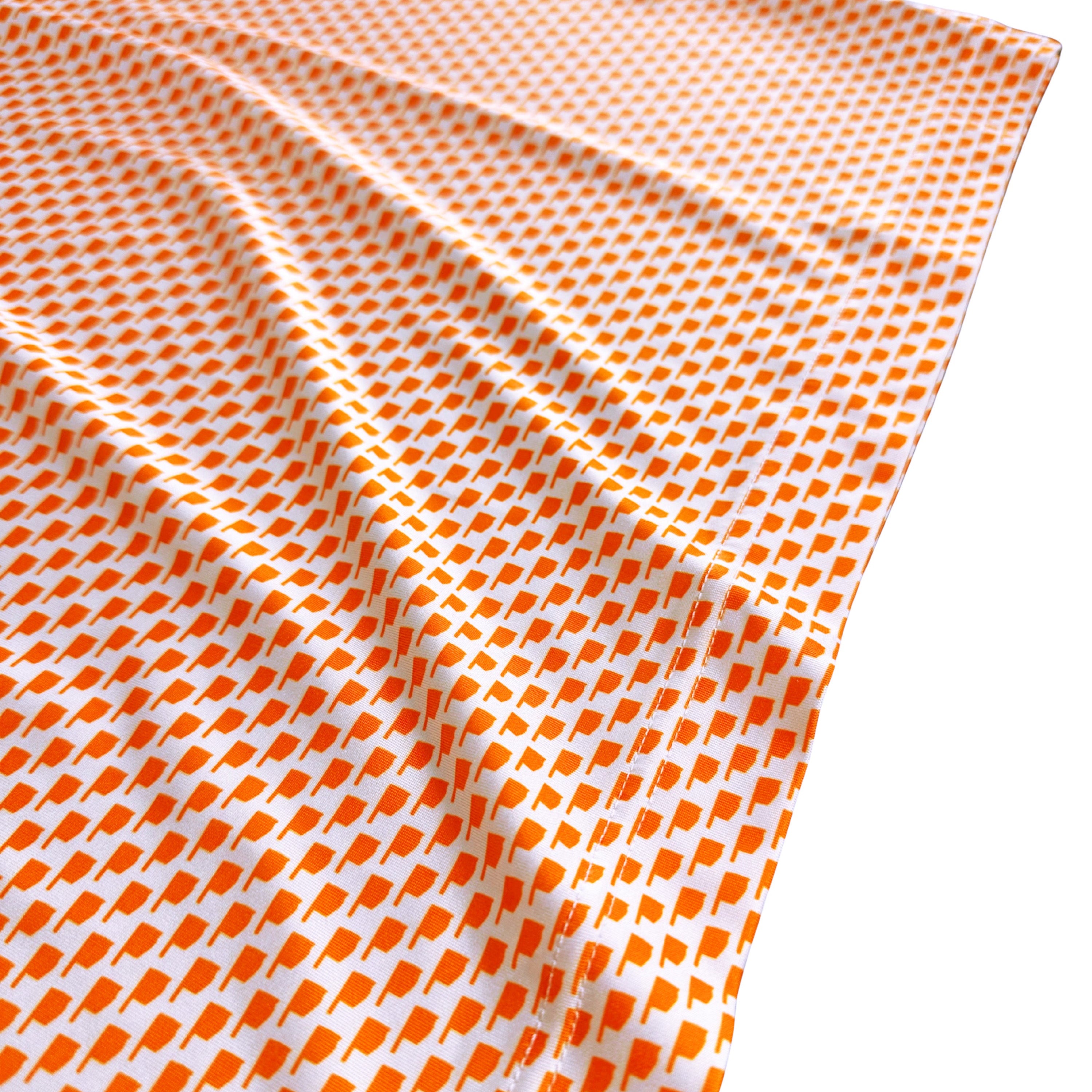 Orange and white checkered fabric on a white background