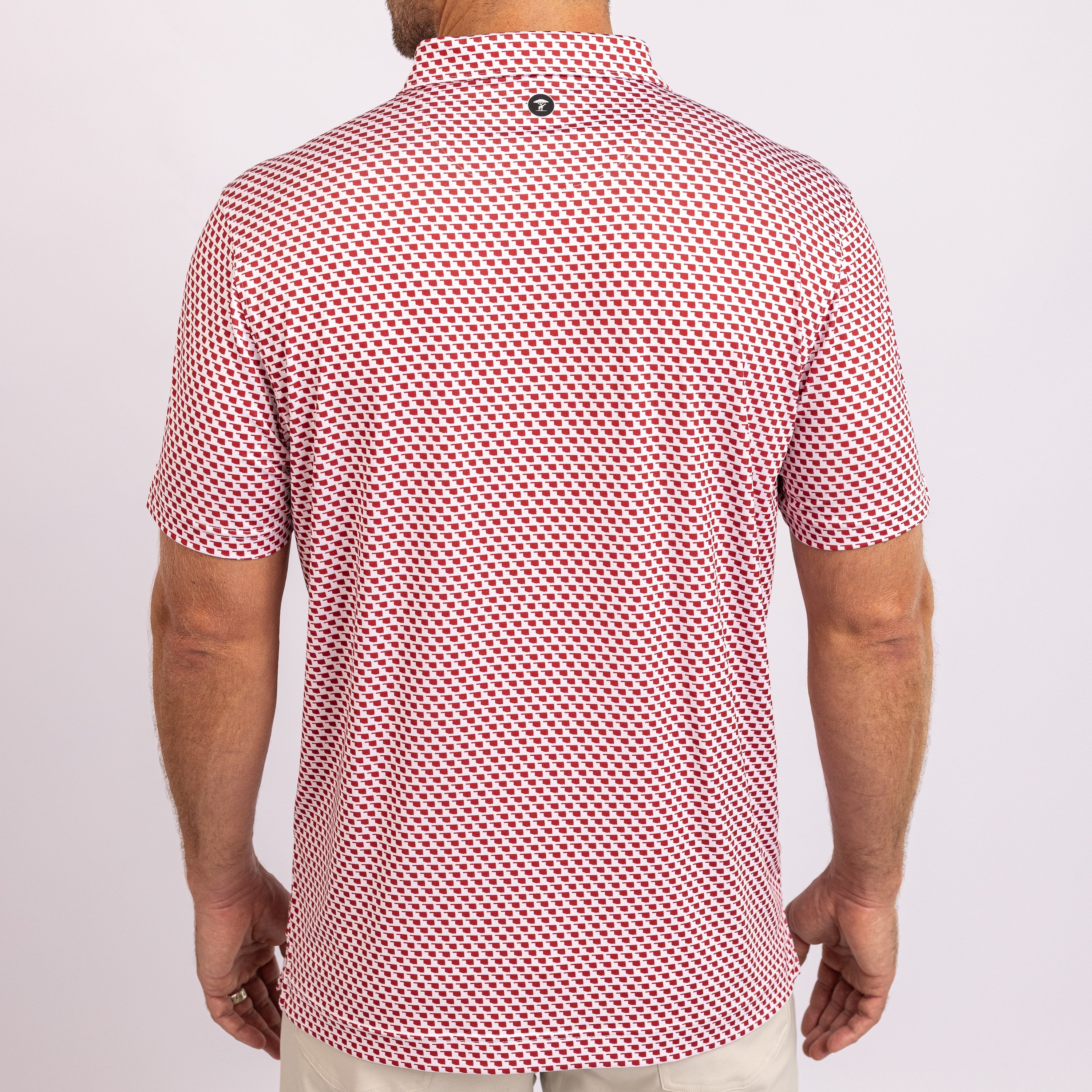 A red and white geometric patterned men's polo shirt with a collar.