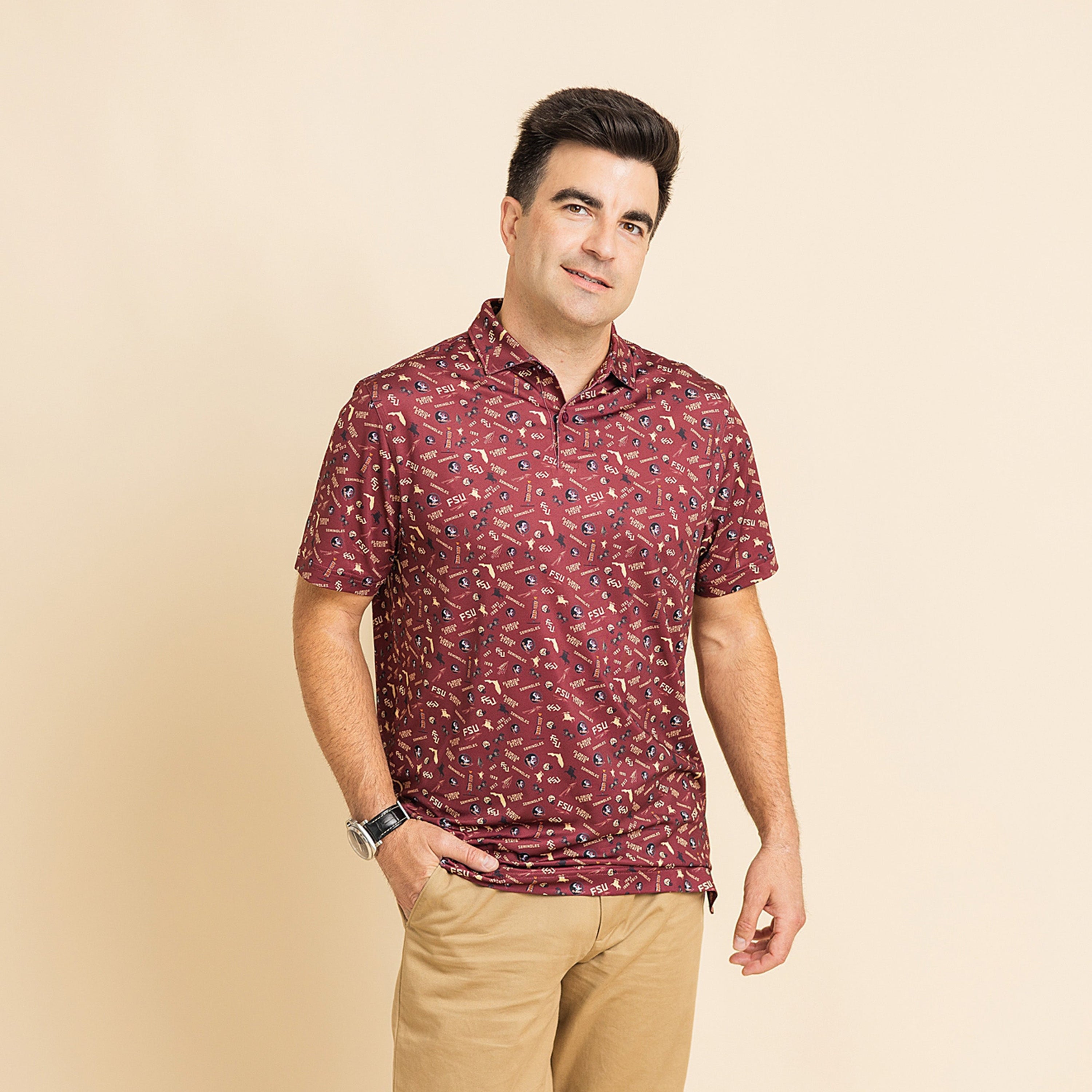 Man wearing a patterned maroon shirt on a beige background