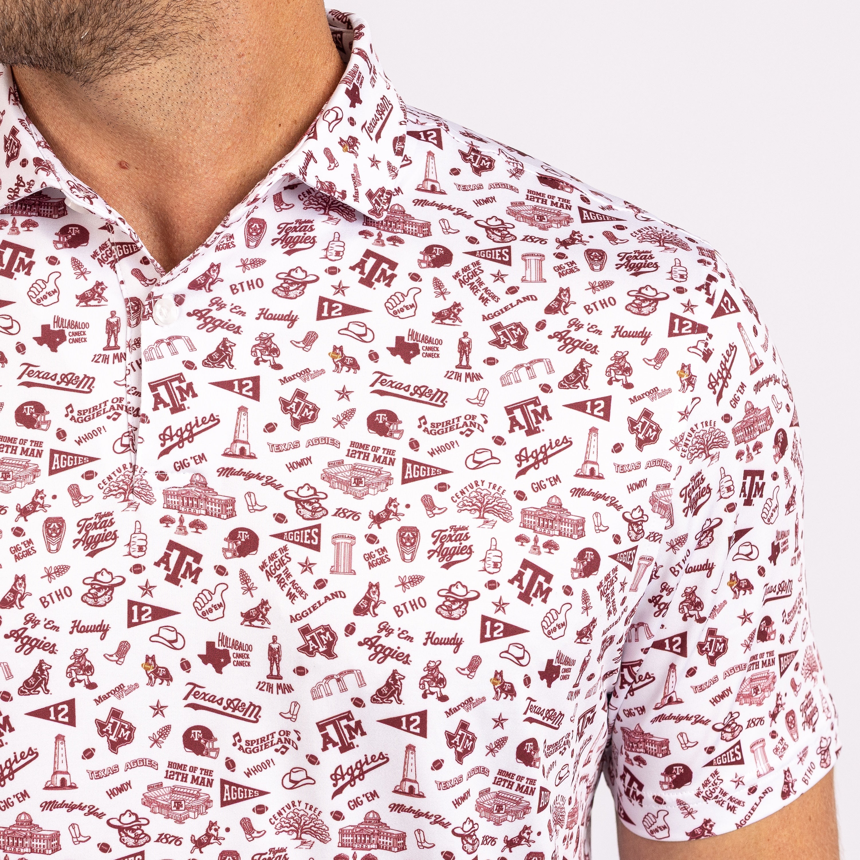 A close-up of a man wearing a white short-sleeve collared polo shirt with an all-over maroon Texas A&M University themed graphic print.