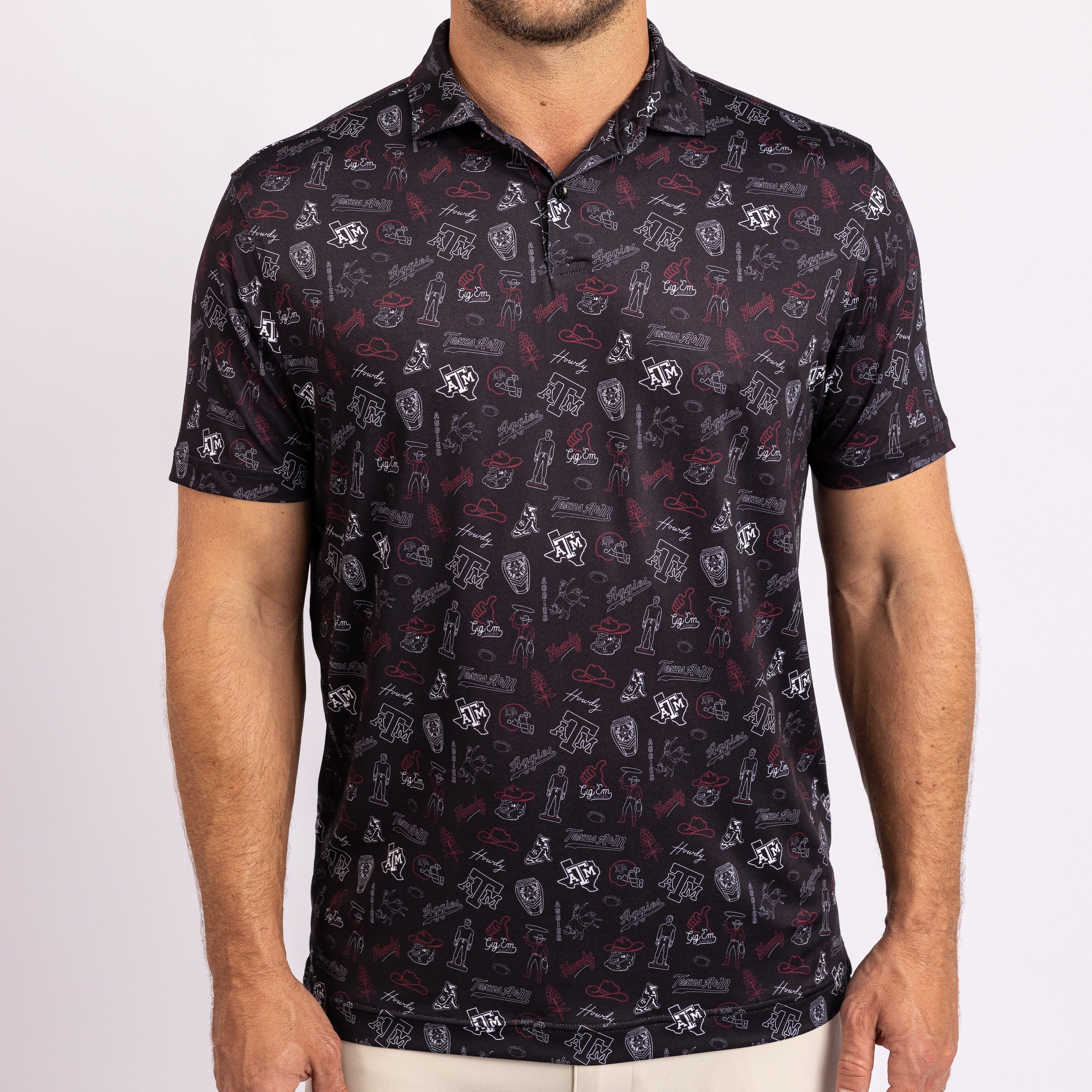 A man wearing a short-sleeve polo shirt with an all-over collegiate-style print.