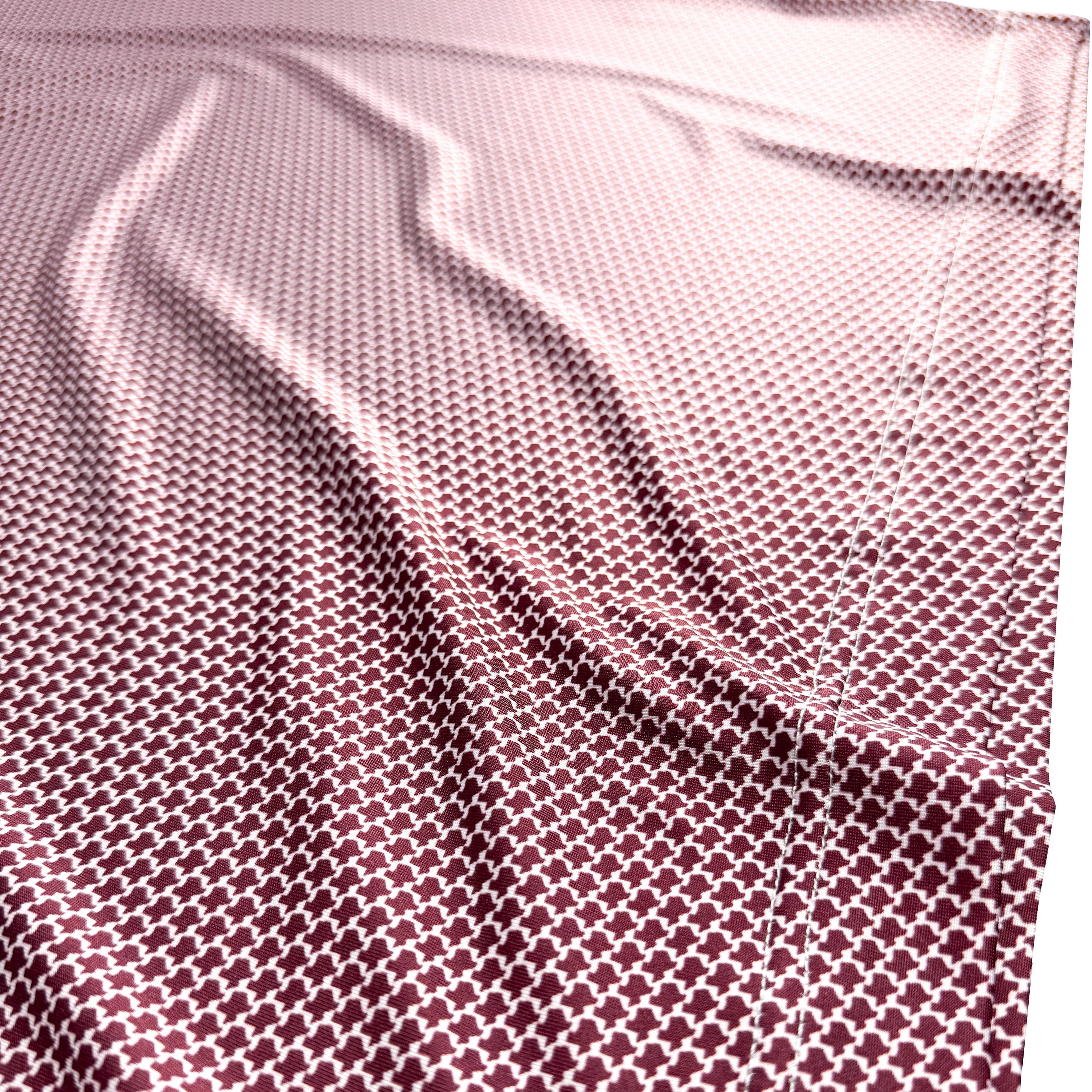Close-up of a textured red fabric with a subtle pattern on a white background