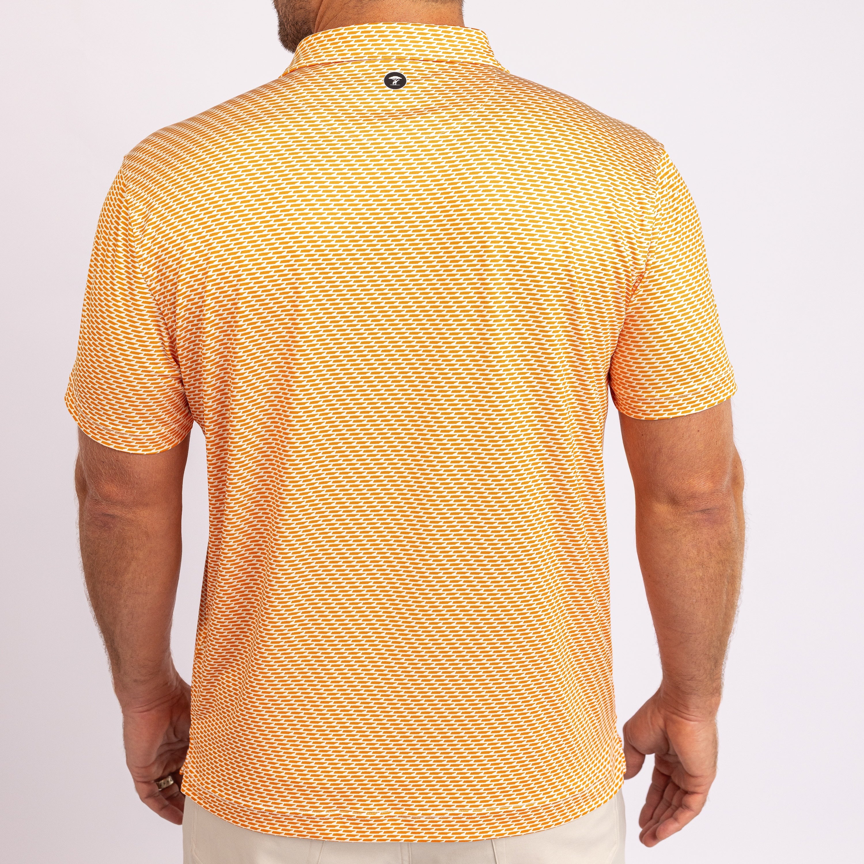 Orange and white patterned polo shirt with a brand logo on a white background