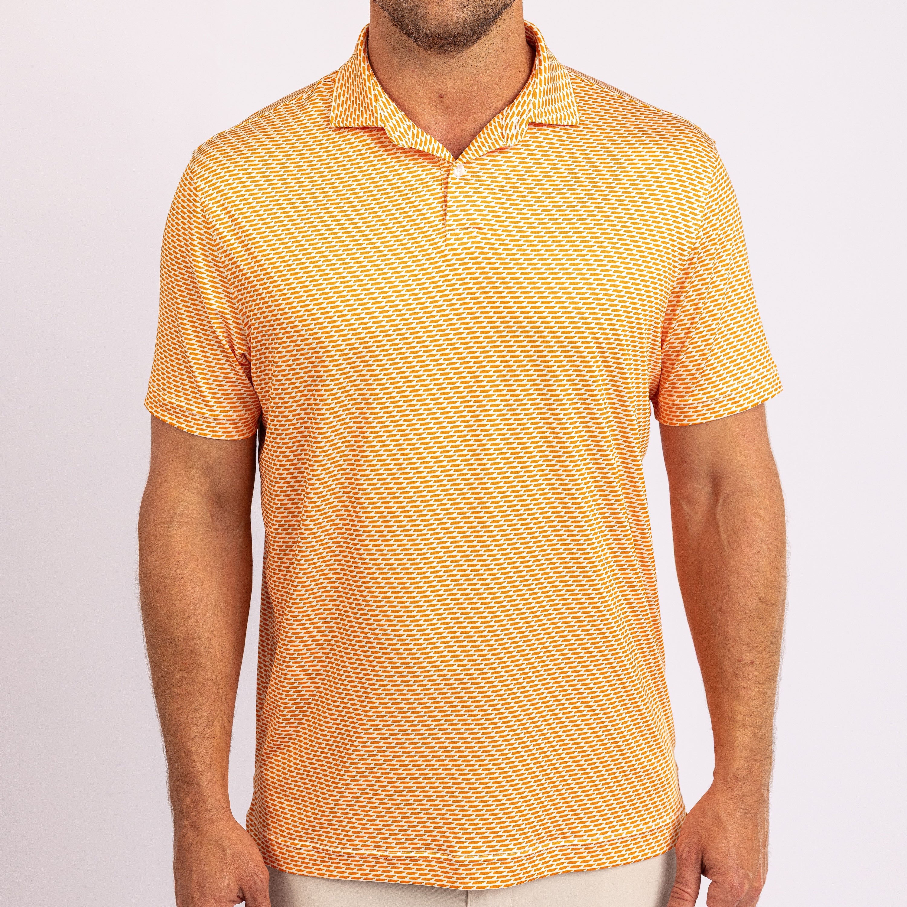 Orange and white patterned polo shirt with a brand logo on a white background