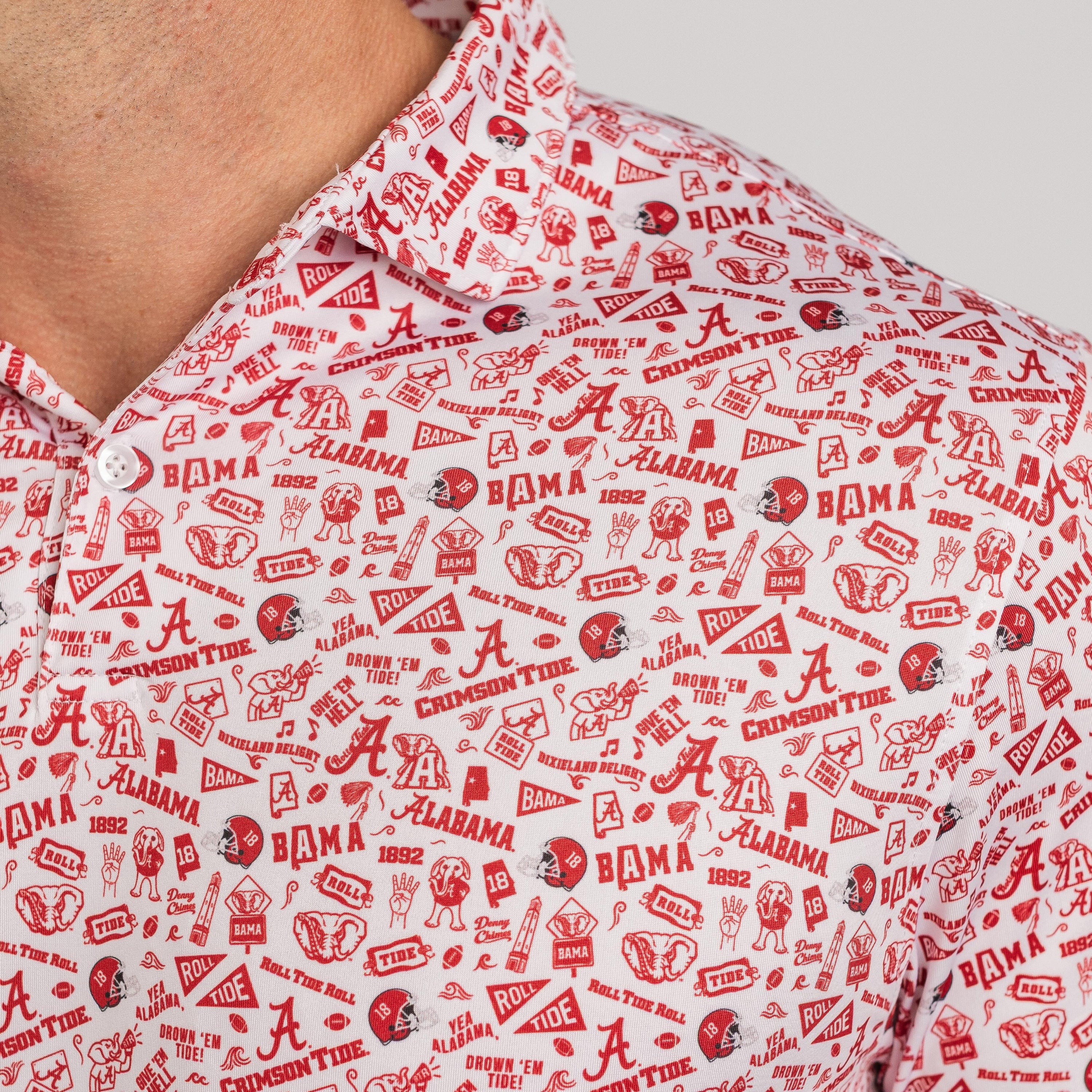 Close-up of a red and white patterned shirt with 'Alabama' logos and text.