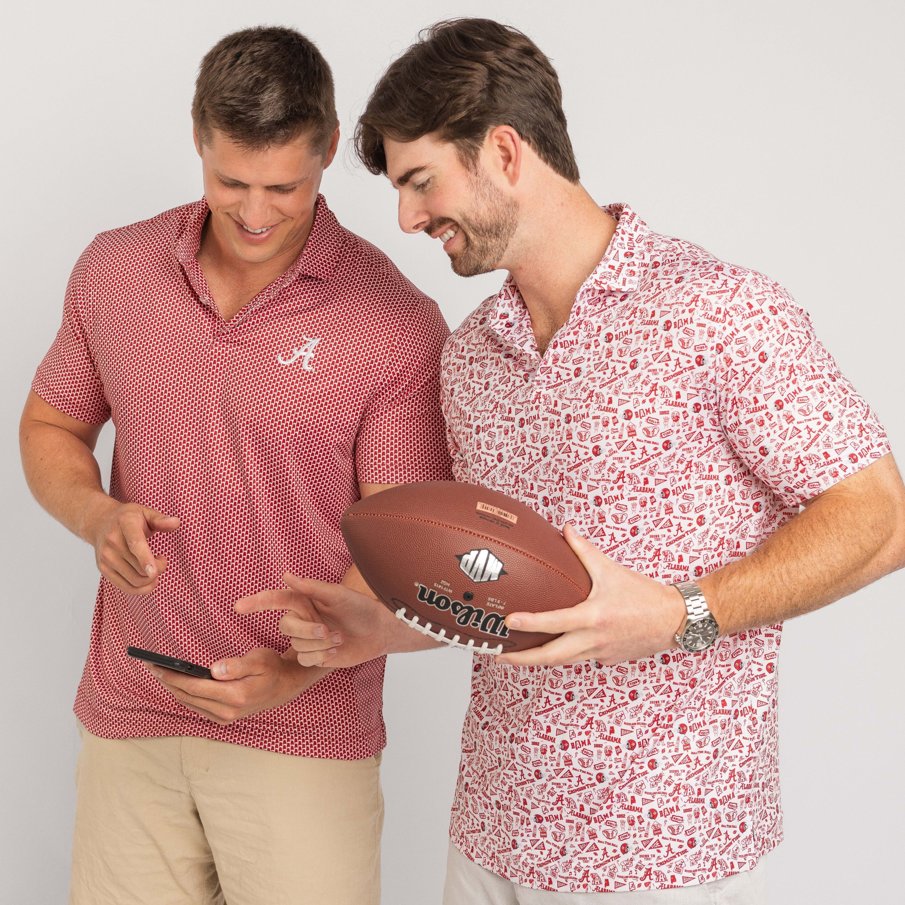 Two men, one holding a football and the other a phone, against a plain background