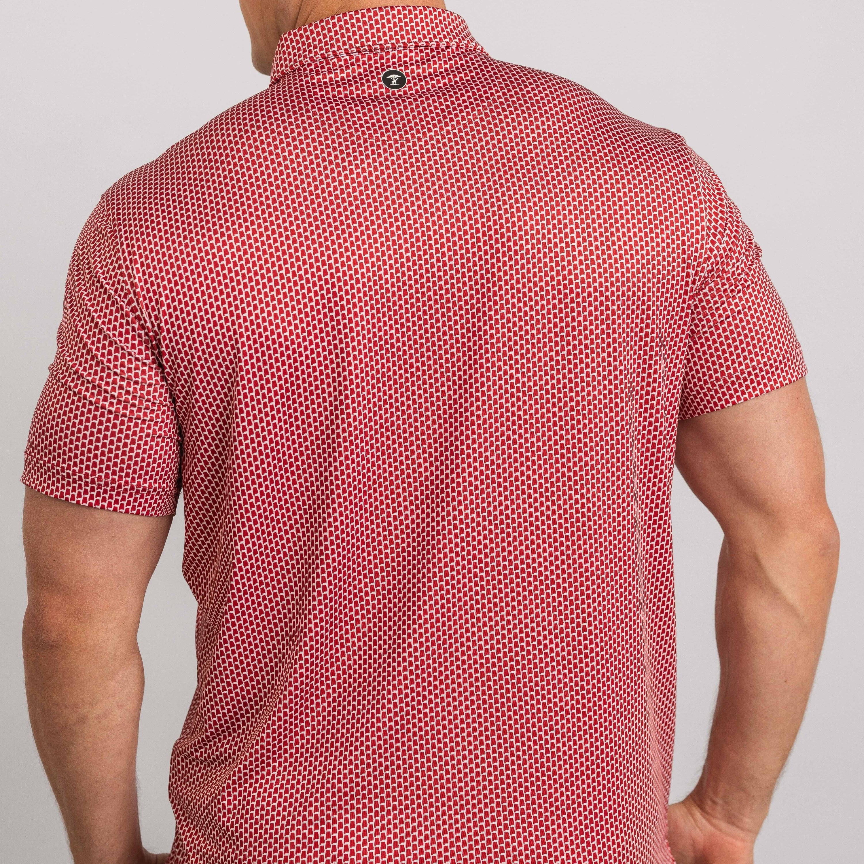 Red patterned short-sleeve shirt worn by a person on a plain background