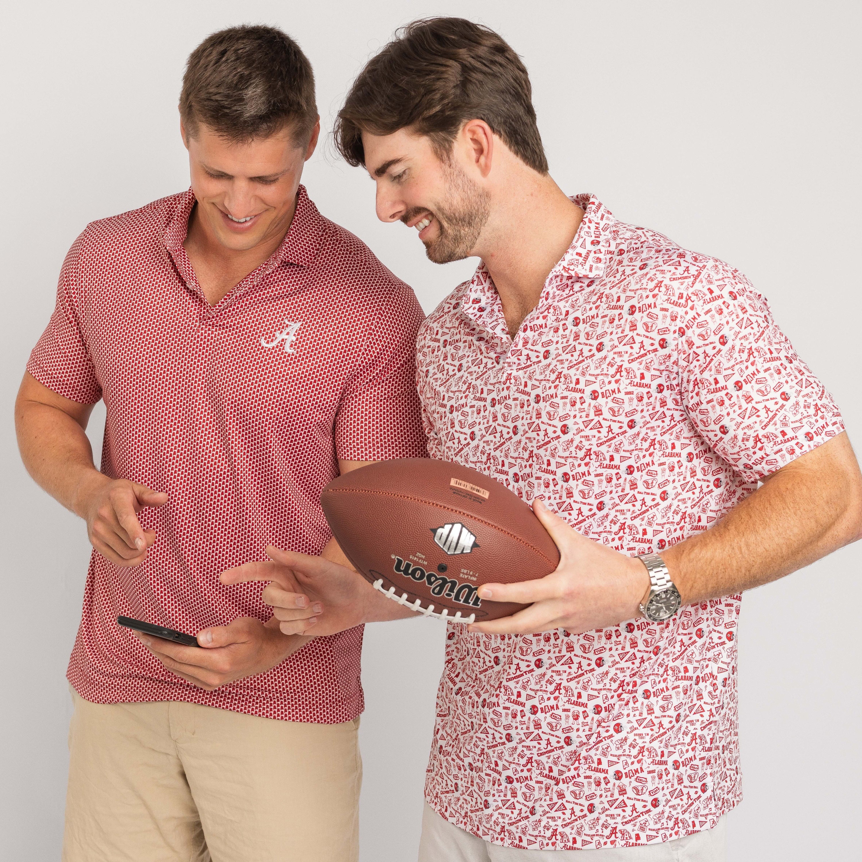 Two men, one holding a football and the other a phone, against a plain background