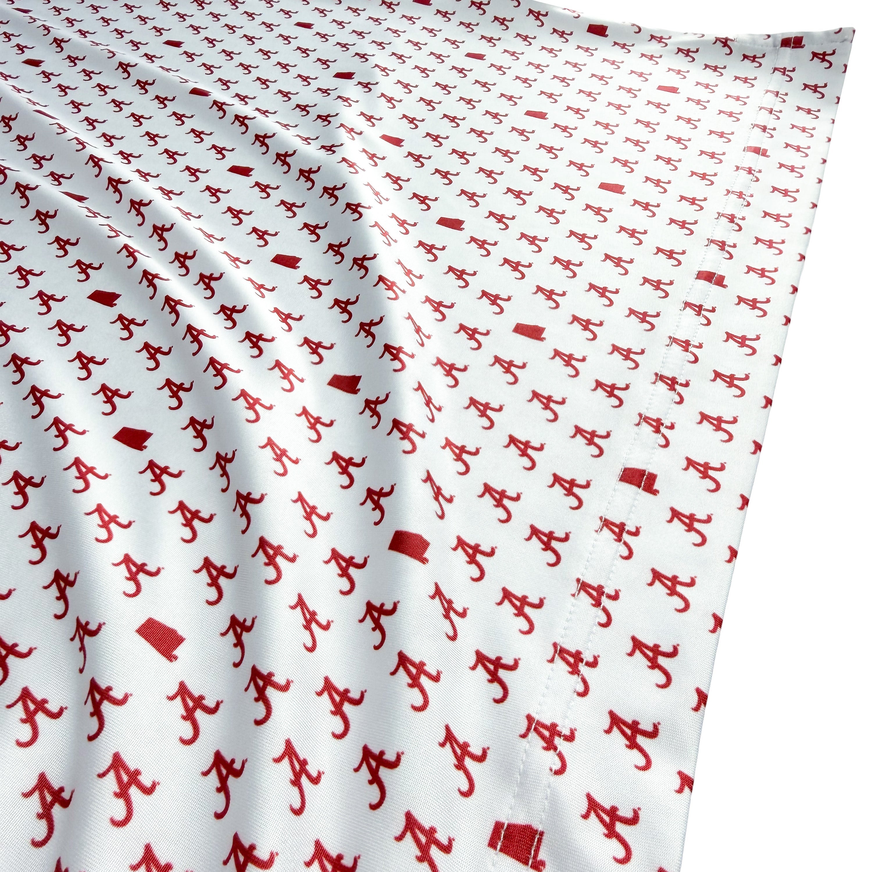 White fabric with red pattern of small figures and shapes
